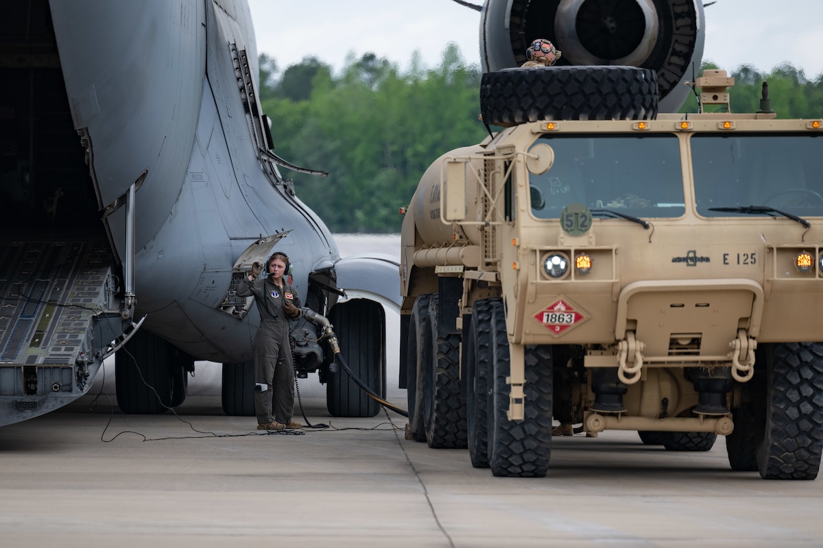 Senior Airman Savannah Hicks with the 155th Airlift Squadron, a unit of the Tennessee Air National Guard 164th Airlift Wing, monitors the transfer of fuel from a C-17 Globemaster III to a Tennessee Army National Guard Heavy Expanded Mobility Tactical Truck on the airfield at Arnold Air Force Base, Tenn., May 14, 2025. This effort was in support of Vigilant Guard, an annual disaster response exercise. Arnold AFB was involved in the portion of Vigilant Guard 2025 focused on airfield management and fuel transfer missions. Guardsmen from the Tennessee National Guard and the North Dakota National Guard were on hand at Arnold to perform the exercise. Arnold AFB Fire and Emergency Services crews supported the effort by maintaining a presence during the arrival and departure of aircraft and throughout the refueling. Arnold crews also received hands on familiarization with the MQ-9 from Guardsmen present. (U.S. Air Force photo by Keith Thornburgh)