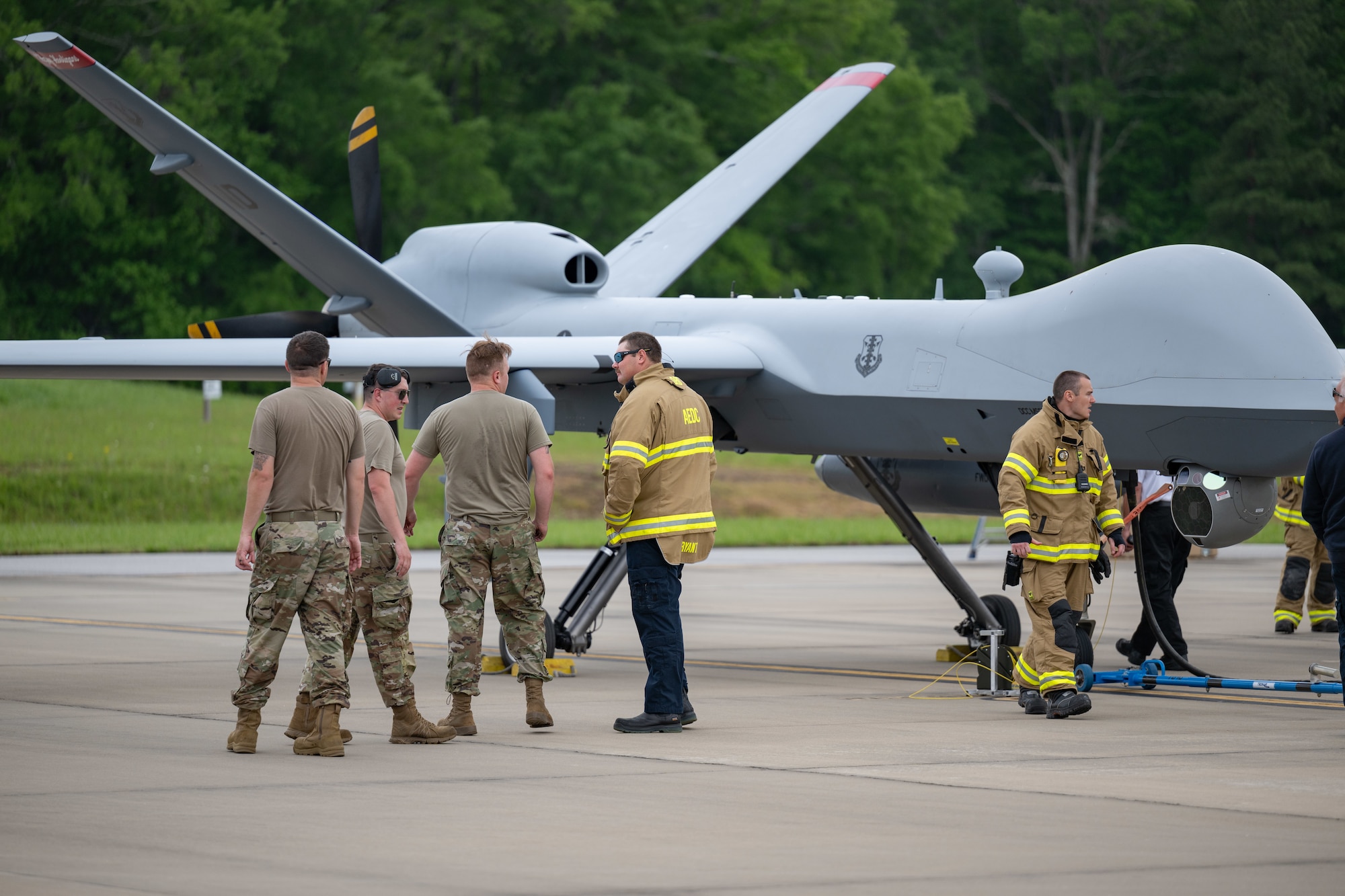 Aircraft Rescue and Fire Fighting crews from Arnold Air Force Base Fire and Emergency Services are familiarized with the MQ-9 Reaper during the portion of the Vigilant Guard exercise conducted at Arnold AFB, Tenn., May 14, 2025. Vigilant Guard is an annual disaster response exercise carried out by National Guard units across the country. Arnold AFB was involved in the portion of Vigilant Guard 2025 focused on airfield management and fuel transfer missions. Guardsmen from the Tennessee National Guard and the North Dakota National Guard were on hand at Arnold to perform the exercise. Arnold AFB Fire and Emergency Services crews supported the effort by maintaining a presence during the arrival and departure of aircraft and throughout the refueling. (U.S. Air Force photo by Keith Thornburgh)