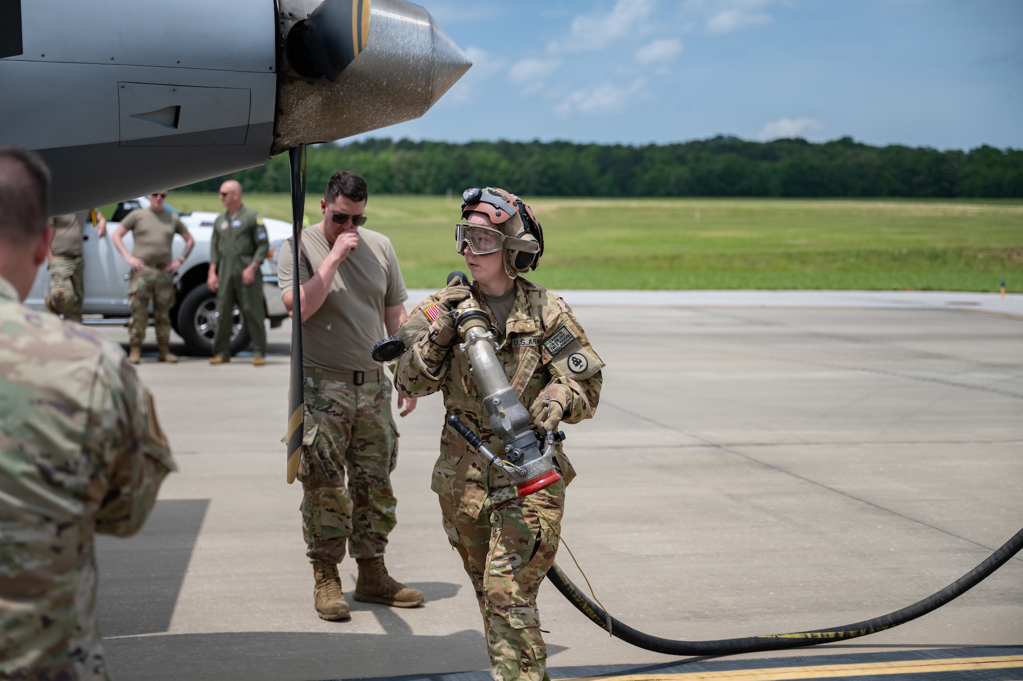 Staff Sgt. Rosetta Wadham with the Tennessee Army National Guard Company E 1-230th Assault Helicopter Battalion prepares to transfer fuel from a Tennessee Army National Guard Heavy Expanded Mobility Tactical Truck to an MQ-9 Reaper aircraft parked on the airfield at Arnold Air Force Base, Tenn., May 14, 2025. This effort was in support of Vigilant Guard, an annual disaster response exercise. Arnold AFB was involved in the portion of Vigilant Guard 2025 focused on airfield management and fuel transfer missions. Guardsmen from the Tennessee National Guard and the North Dakota National Guard were on hand at Arnold to perform the exercise. Arnold AFB Fire and Emergency Services crews supported the effort by maintaining a presence during the arrival and departure of aircraft and throughout the refueling. Arnold crews also received hands on familiarization with the MQ-9 from Guardsmen present. (U.S. Air Force photo by Keith Thornburgh)