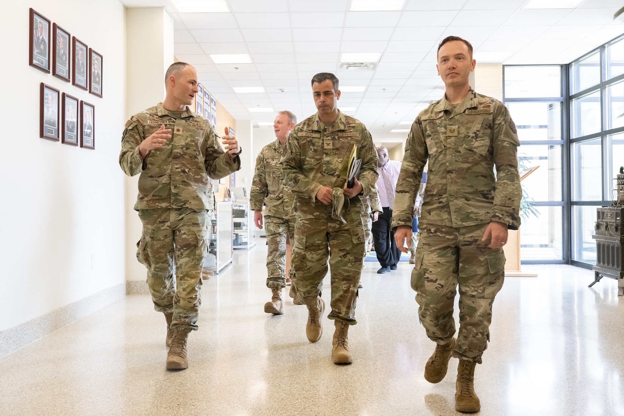 U.S. Air Force Col. Jamil Musa, center, 436th Airlift Wing commander, walks through the 436th Communications Squadron building during a command team immersion tour at Dover Air Force Base, Delaware, June 3, 2025. The new command team toured various units within the 436th Mission Support Group to familiarize themselves with their mission and capabilities. (U.S. Air Force photo by Mauricio Campino)