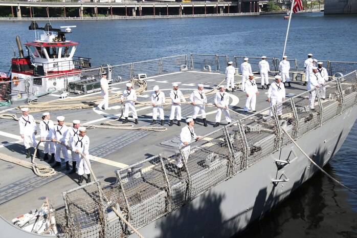 PORTLAND, Ore. (June 3, 2025) – Sailors aboard the Arleigh Burke-class guided-missile destroyer USS Mustin (DDG 89) handle lines as the ship arrives for Portland Fleet Week during the 118th Rose Festival, June 3, 2025.  Portland Fleet Week is a time-honored celebration of the sea services and provides an opportunity for the citizens of Oregon to meet Sailors, Marines and Coast Guardsmen, as well as witness firsthand the latest capabilities of today’s maritime services. (U.S. Navy Photo by Mass Communication Specialist 2nd Class Kassandra Alanis)