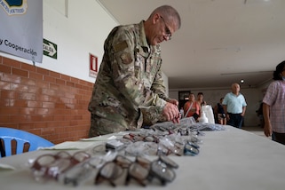 U.S. Air Force Tech. Sgt. Thomas Eckler, AMISTAD Logistics Lead, unpacks prescription eyeglasses for the AMISTAD optometry clinic in Iquitos, Peru, June 2, 2025. Through total force integration, Reserve and Active-Duty Airmen work together and with partners nations to hone skills required for medical and crisis response. (U.S. Air Force photo by Senior Airman Victoria Edwards)