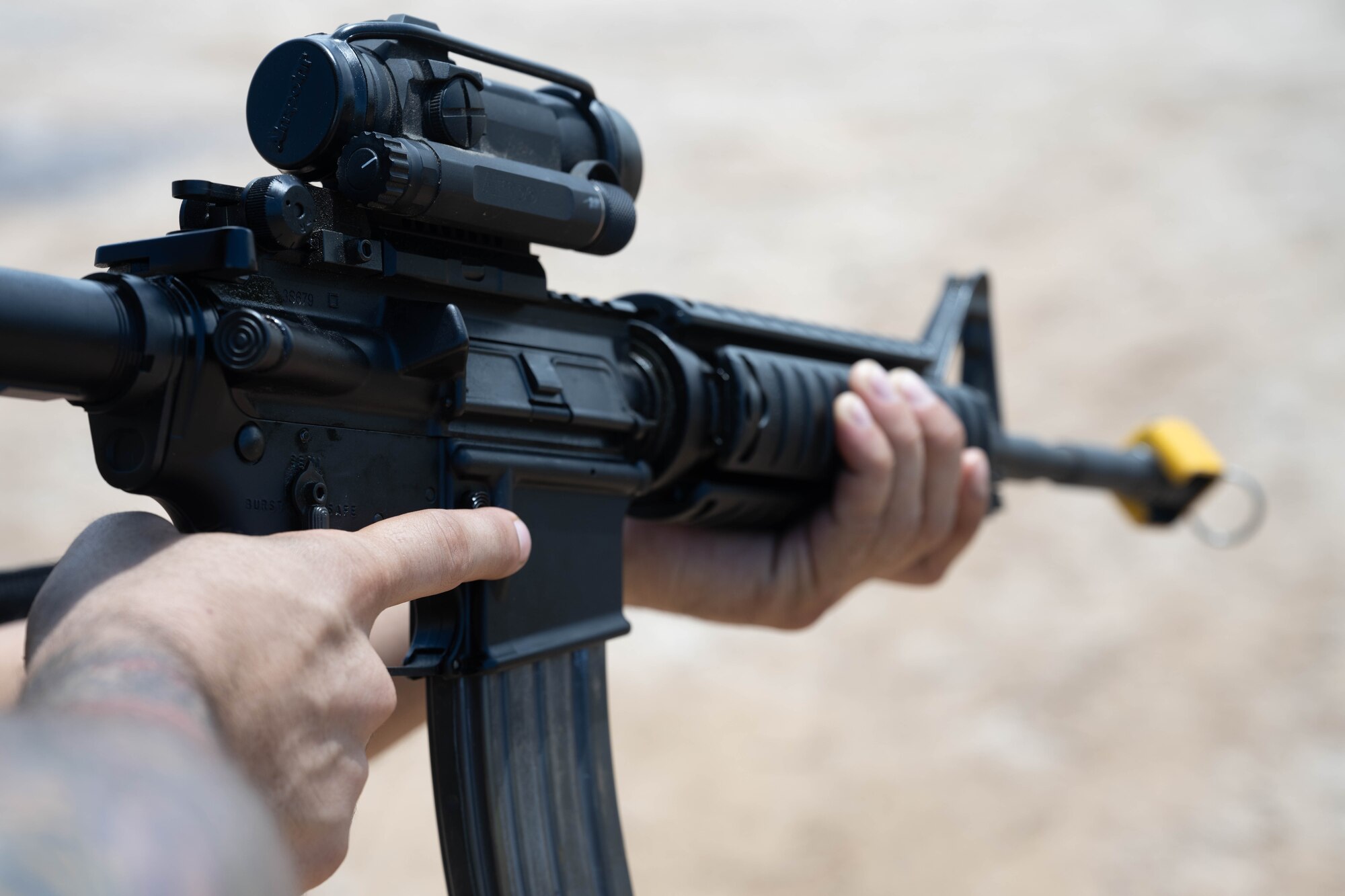 U.S. Air Force Airmen aims his weapons at a potential threat during an exercise.