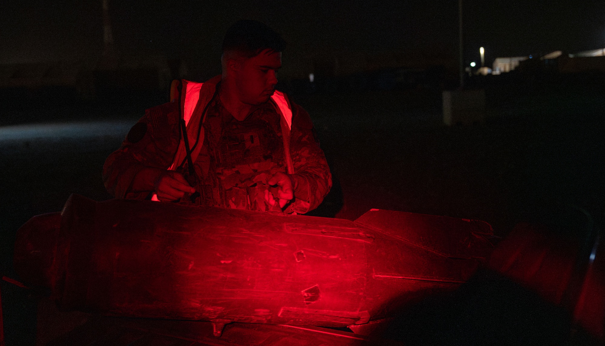 A man unloads a training ordnance from a truck.