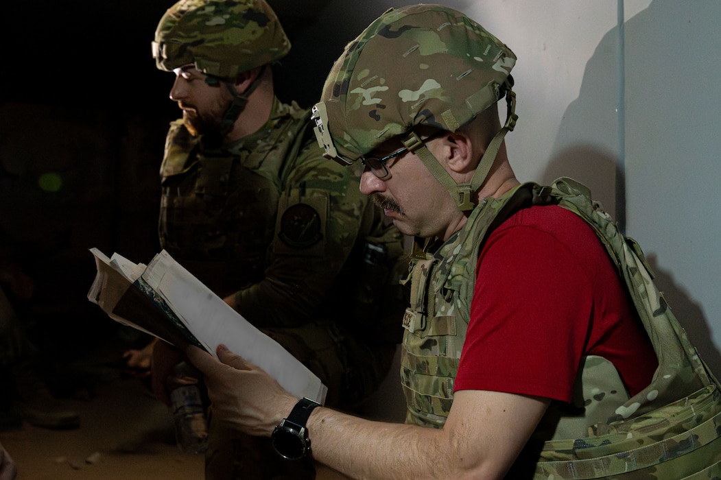A man reads a paper in a bunker.