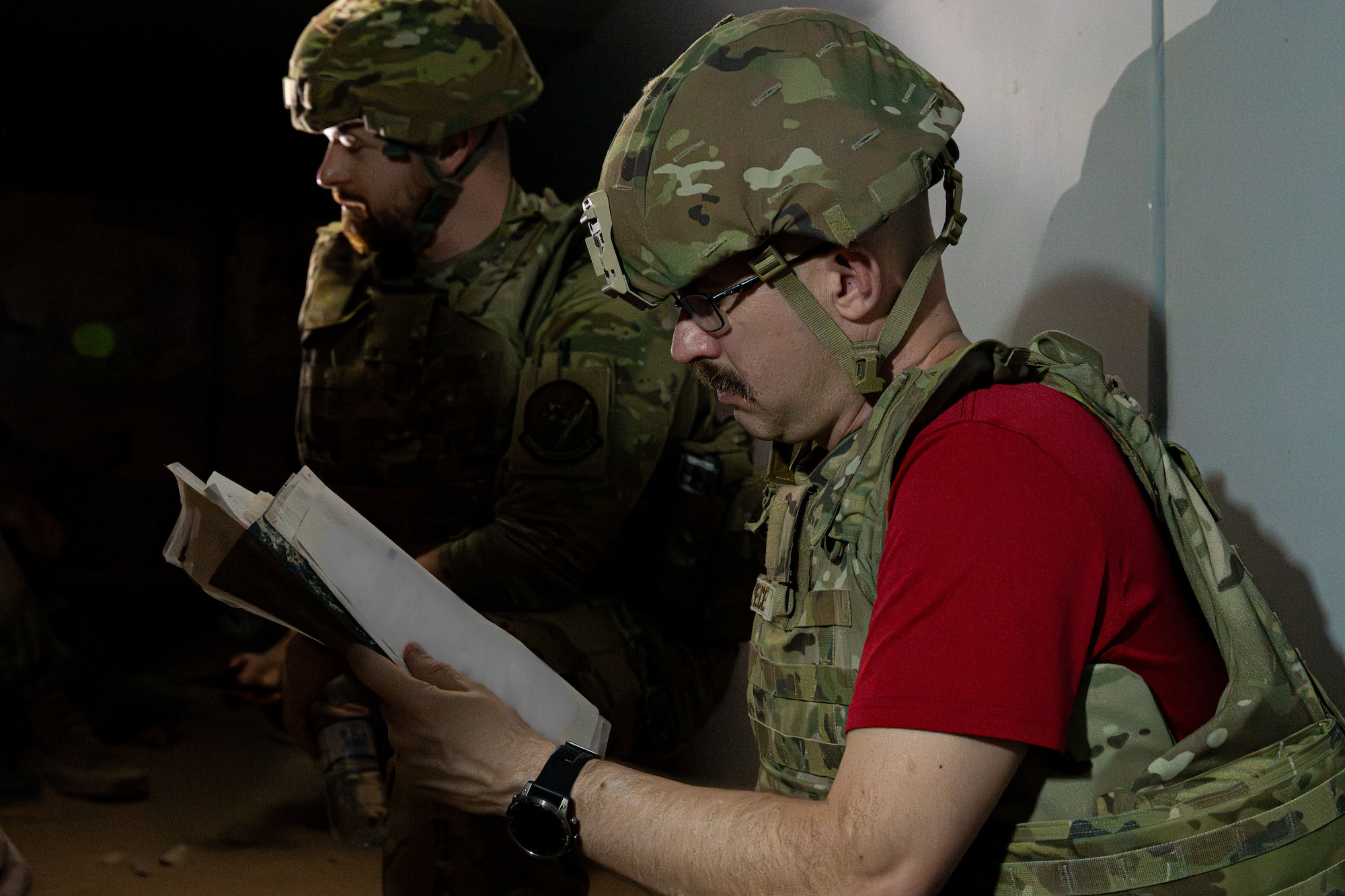 A man reads a paper in a bunker.