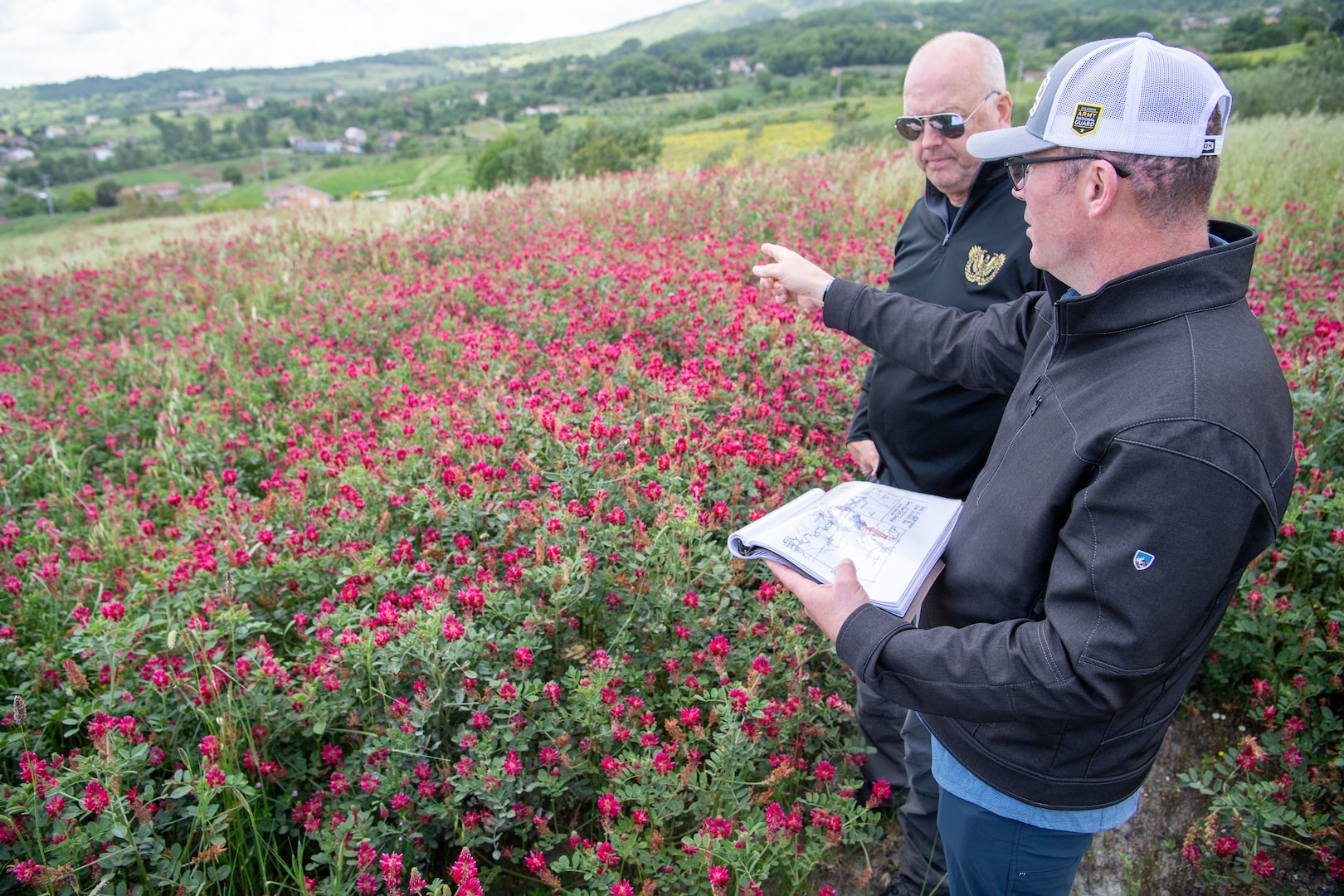 Lt. Col. Luke Kimbrel, commander of the 1st Battalion, 279th Infantry Regiment, 45th Infantry Brigade Combat Team, and Chief Warrant Officer 5 Greg Kratochwill, command chief warrant officer for the Oklahoma National Guard, survey a hillside near Oliveto, Italy, on May 6, 2025, where in 1943 2nd Lt. Ernest Childers led an assault against German troops that would result in him being presented with the Medal of Honor for his valorous actions. The hill, now called Heroes’ Hill by locals, is one the many sites Oklahoma National Guard leadership is evaluating for possible monuments and memorials commemorating the 45th Infantry Division’s World War II service. (Oklahoma National Guard photo by Staff Sgt. Anthony Jones)