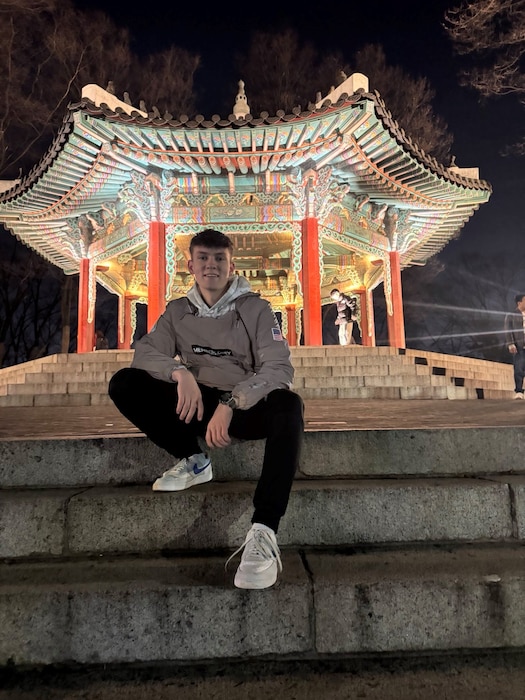 An Airman sits in front of a Korean temple.