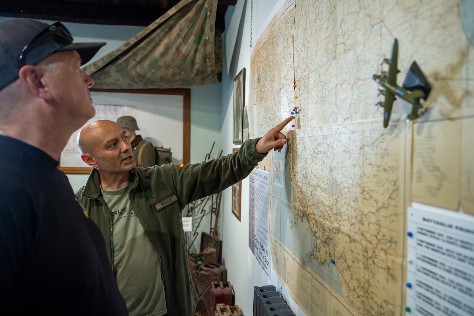 Luciano Bucci, owner of the Winterline Museum in Venafro, Italy, and Chief Warrant Officer 5 Greg Kratochwill, command chief warrant officer for the Oklahoma National Guard, discuss 45th Infantry Division positions along the Winter Line, a series of WWII German defenses in southern Italy, while giving Oklahoma National Guard members a tour of his museum on May 9. (Oklahoma National Guard photo by Staff Sgt. Anthony Jones)