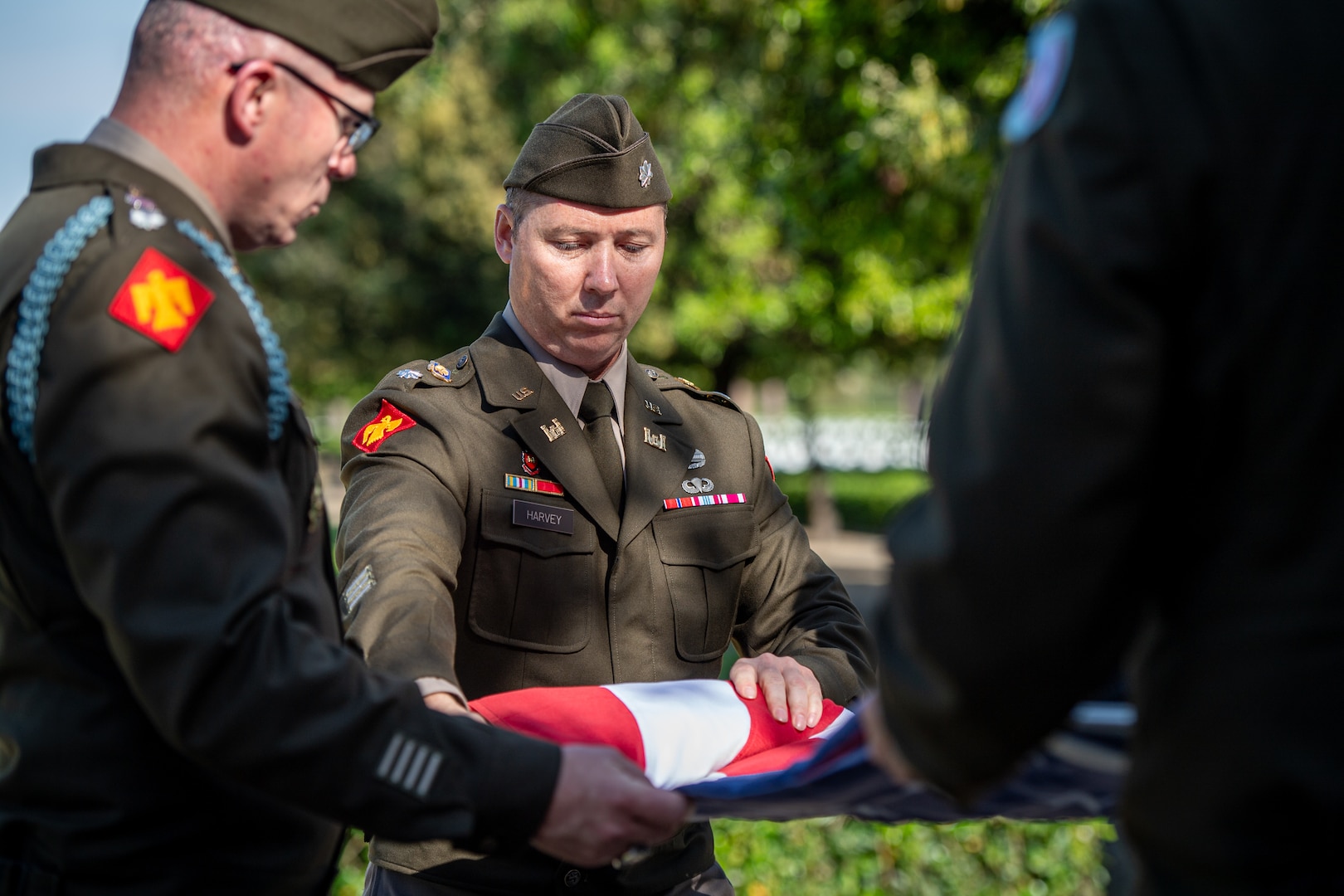 Lt. Col. Neal Harvey, commander of the 545th Brigade Engineer Battalion, 45th Infantry Brigade Combat Team, folds the U.S. flag during the end of day closing ceremony at he Sicily-Rome American Cemetery and Memorial in Nettuno, Italy, May 10, 2025. Oklahoma National Guard leaders visited the cemetery and memorial to honor the 45th ID members who were killed in action during the campaign to free Italy during WWII. (Oklahoma National Guard photo by Staff Sgt. Anthony Jones)