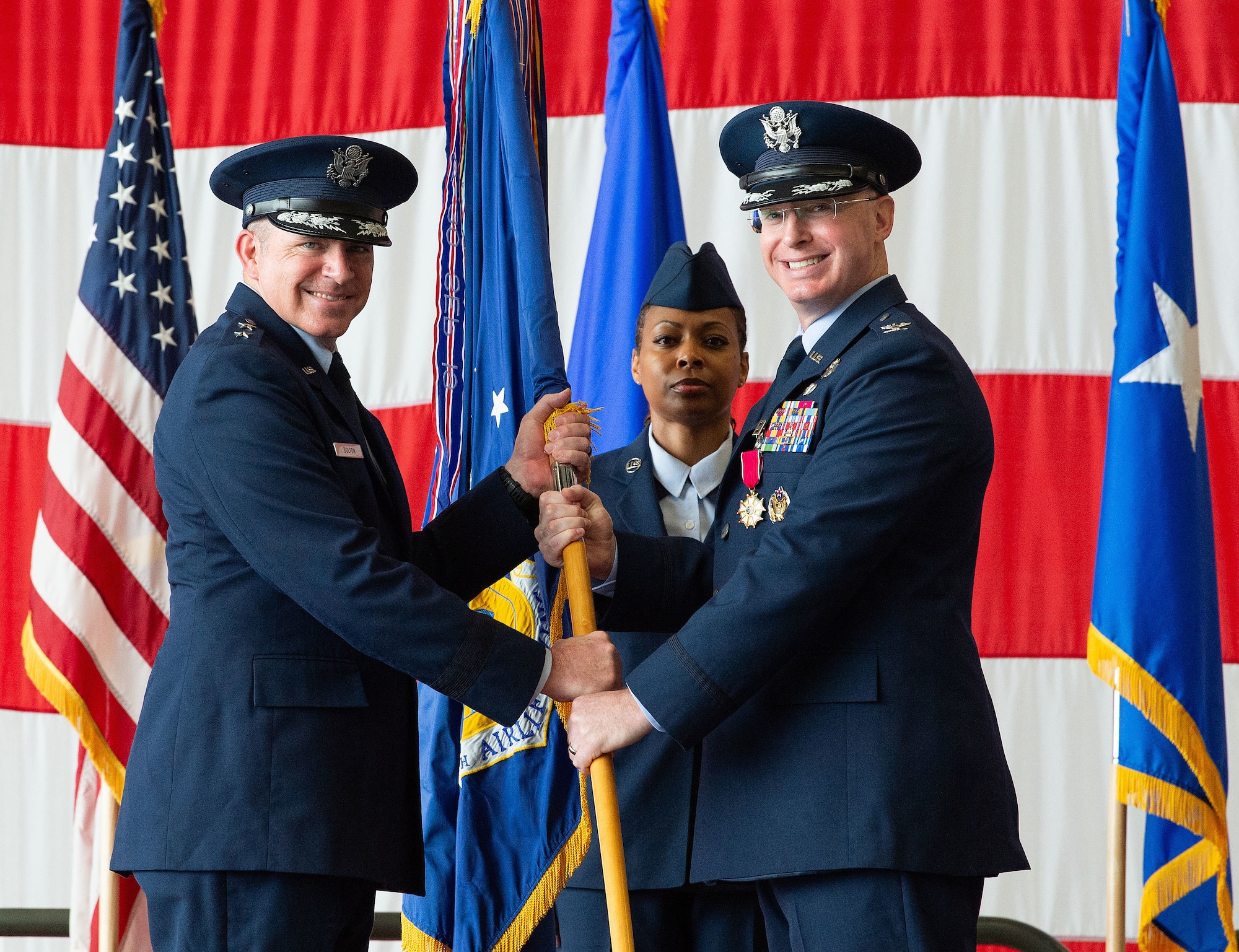 U.S. Air Force Maj. Gen. Charles Bolton, Eighteenth Air Force commander, receives the 436th Airlift Wing guidon from Col. William ‘Chris’ McDonald, 436th AW outgoing commander, during a change of command ceremony on Dover Air Force Base, Delaware, May 30, 2025. McDonald relinquished command in a ceremony attended by friends, family, Team Dover members, local civic leaders and distinguished visitors. (U.S. Air Force photo by Roland Balik)