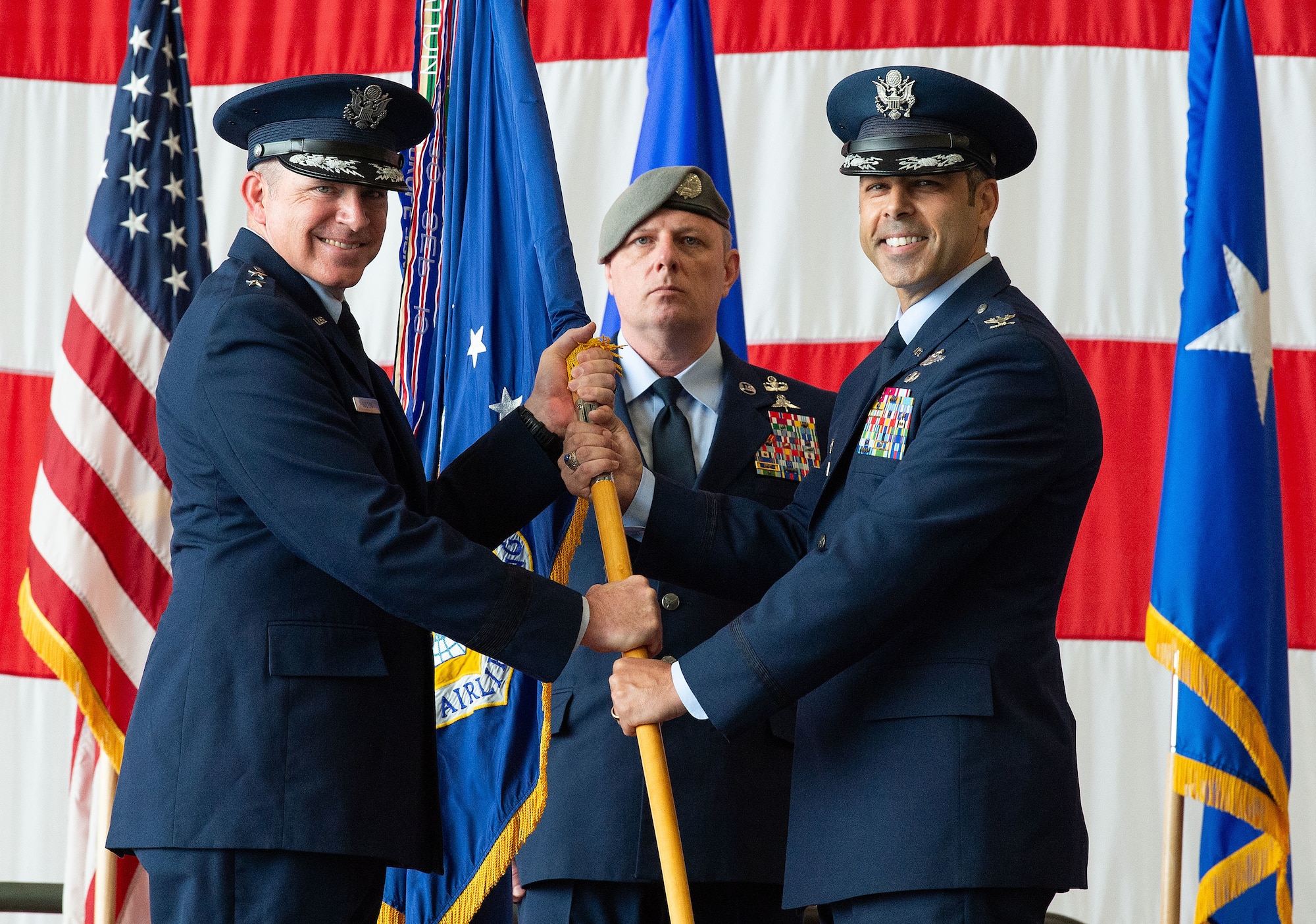 U.S. Air Force Maj. Gen. Charles Bolton, Eighteenth Air Force commander, presents the 436th Airlift Wing guidon to Col. Jamil Musa, 436th AW commander, during a change of command ceremony on Dover Air Force Base, Delaware, May 30, 2025. Upon taking command, Musa became the wing’s 38th commander. (U.S. Air Force photo by Roland Balik)