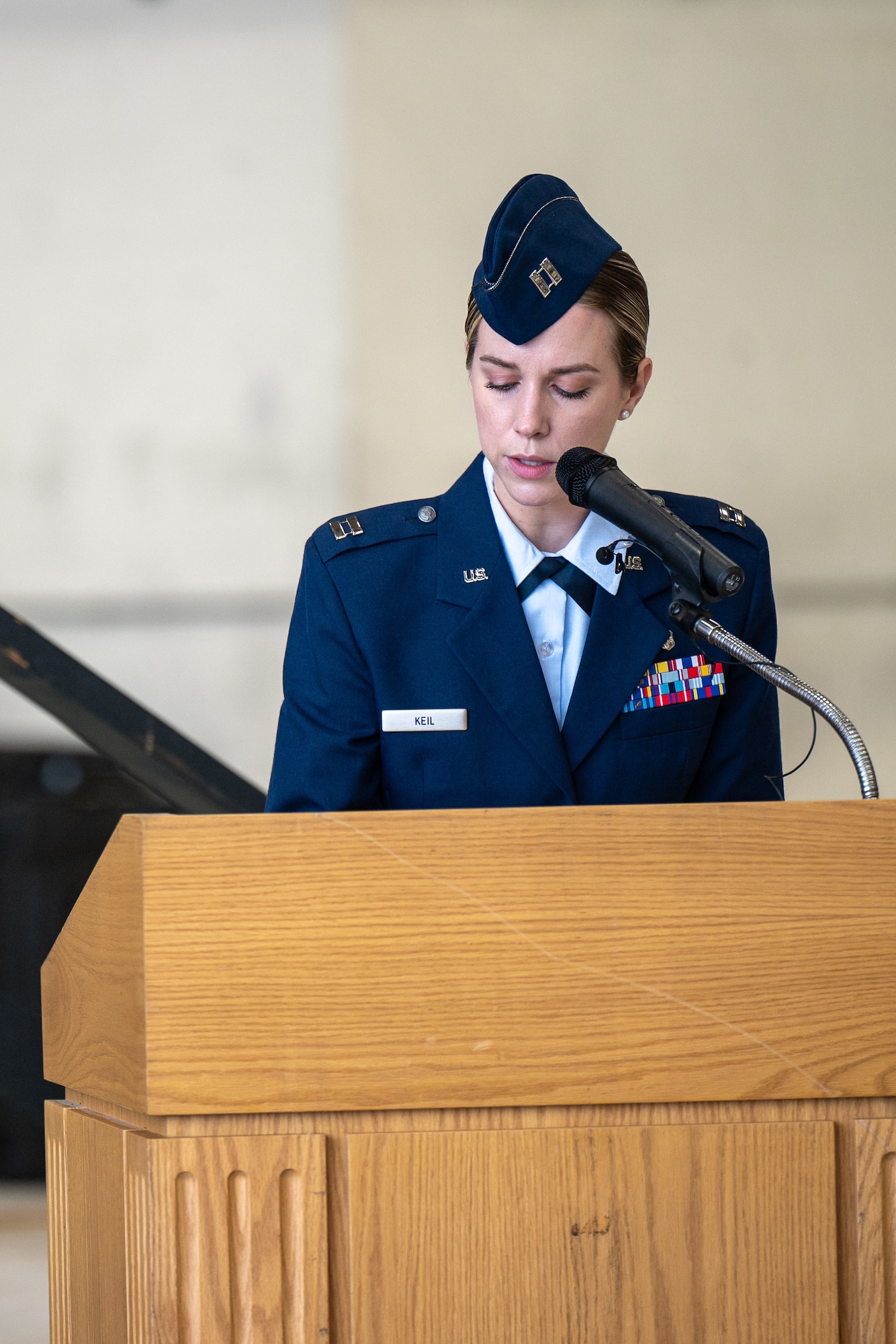 U.S. Air Force Capt. Kaylam Keil, 436th Medical Group medical information system flight commander, narrates during the 436th Airlift WIng Change of Command ceremony on Dover Air Force Base, Delaware, May 30, 2025. Col. Jamil Musa took command of the Eagle Wing in a ceremony officiated by the 18th Air Force commander Maj. Gen. Charles Bolton. (U.S. Air Force photo by Senior Airman Trenten Walters)