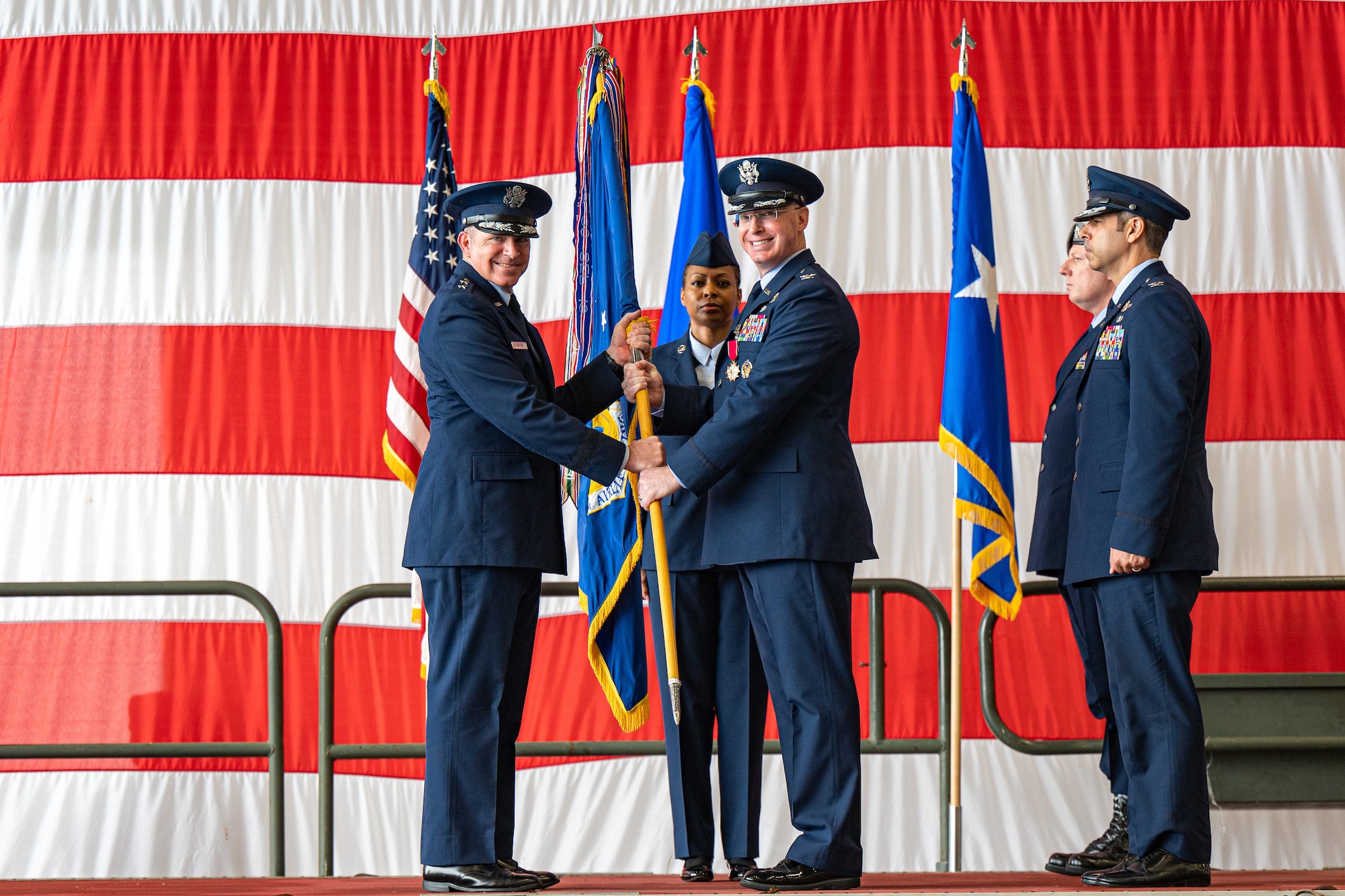 U.S. Air Force Maj. Gen. Charles Bolton, Eighteenth Air Force commander, receives the 436th Airlift Wing guidon from Col. William ‘Chris’ McDonald, 436th AW outgoing commander, during a change of command ceremony on Dover Air Force Base, Delaware, May 30, 2025. McDonald relinquished command in a ceremony attended by friends, family, Team Dover members, local civic leaders and distinguished visitors. (U.S. Air Force photo by Senior Airman Trenten Walters)