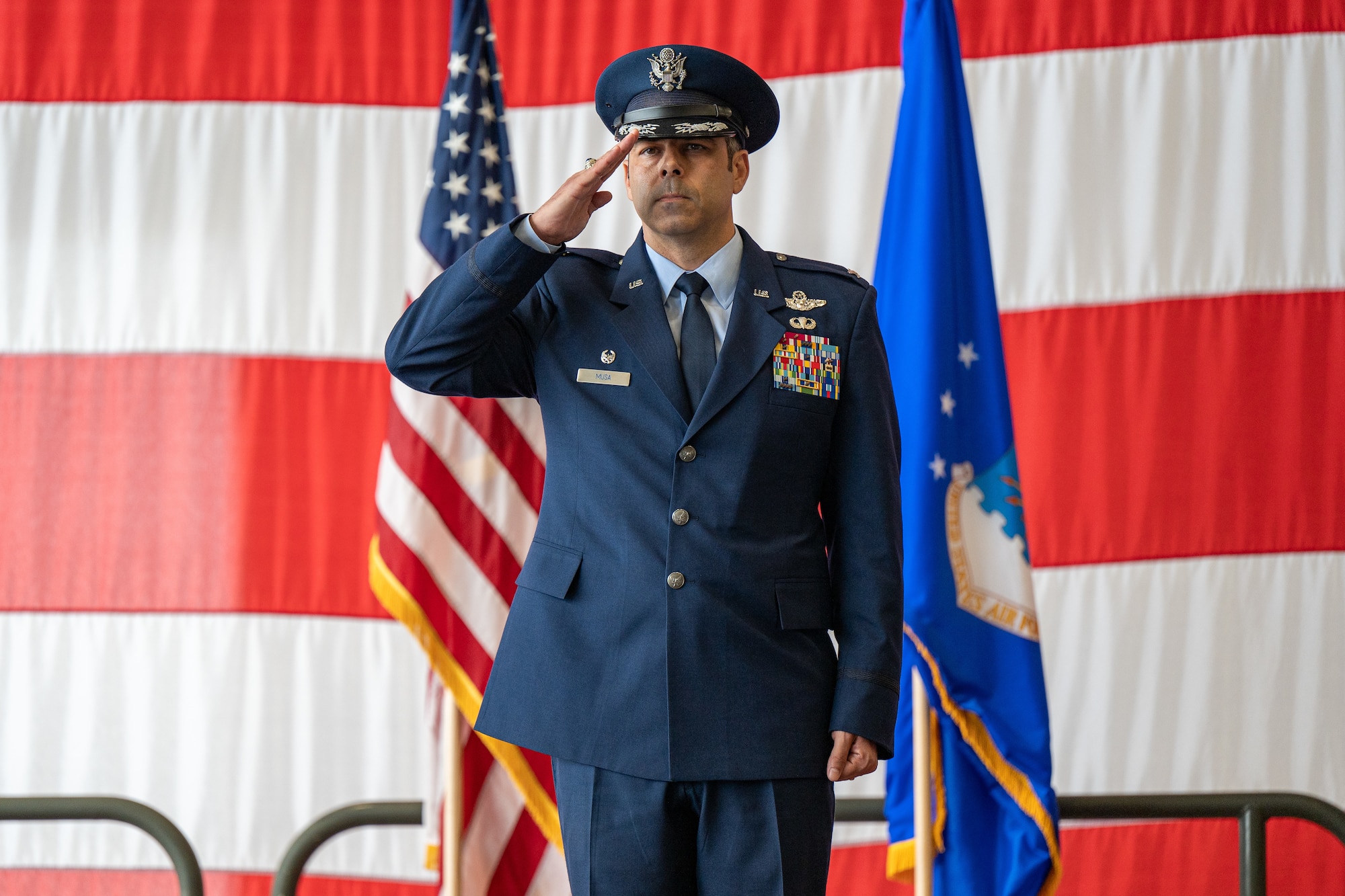 U.S. Air Force Col. Jamil Musa, 436th Airlift Wing commander, receives his first salute from a formation of Team Dover Airmen during the 436th AW change of command ceremony on Dover Air Force Base, Delaware, May 30, 2025. Musa takes command following an assignment as the deputy commander of the 86th Airlift Wing at Ramstein Air Base, Germany. (U.S. Air Force photo by Senior Airman Trenten Walters)