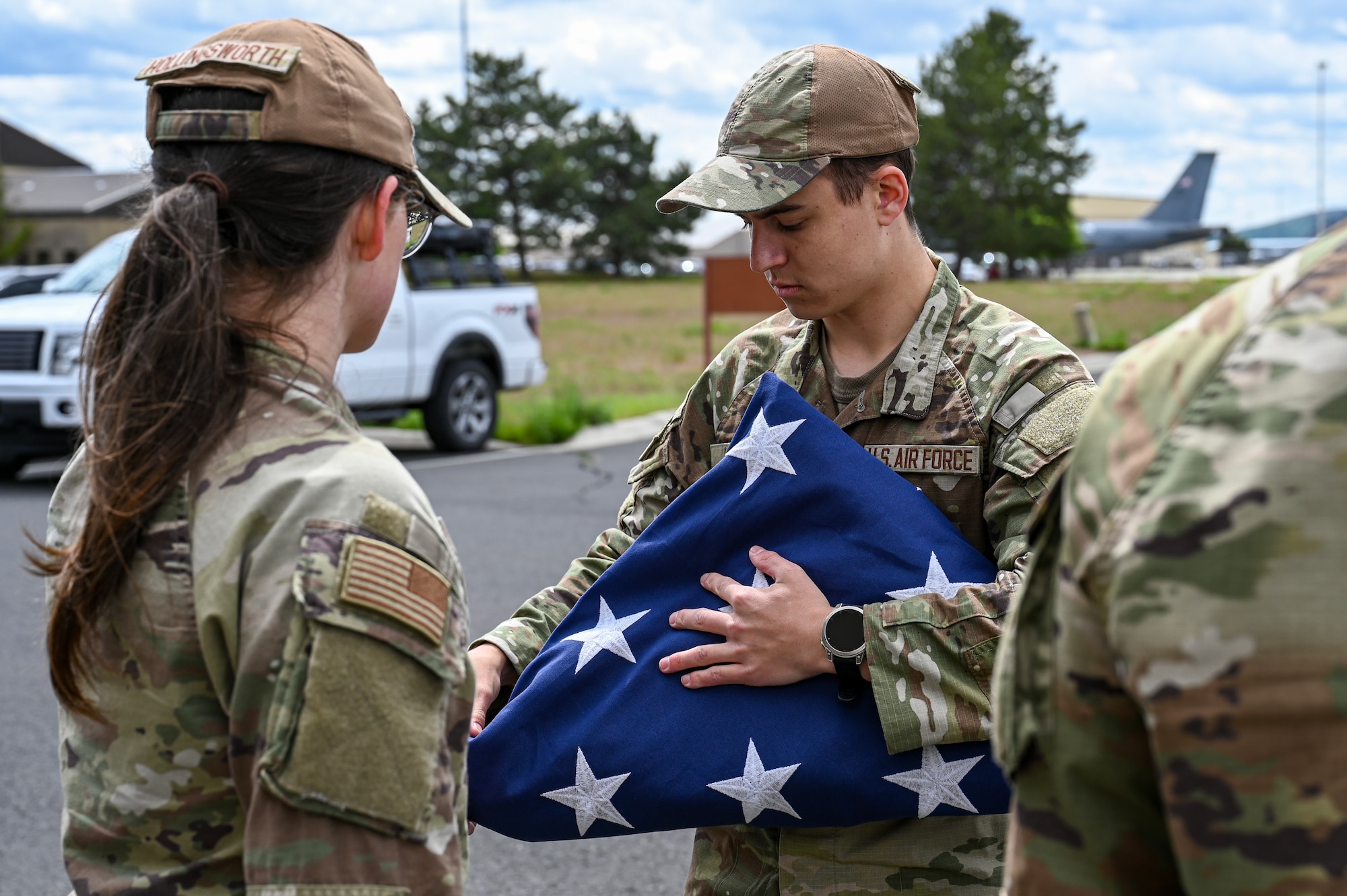 Airmen fold a flag