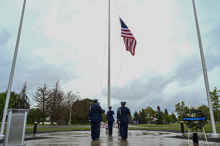 Airmen salute a flag