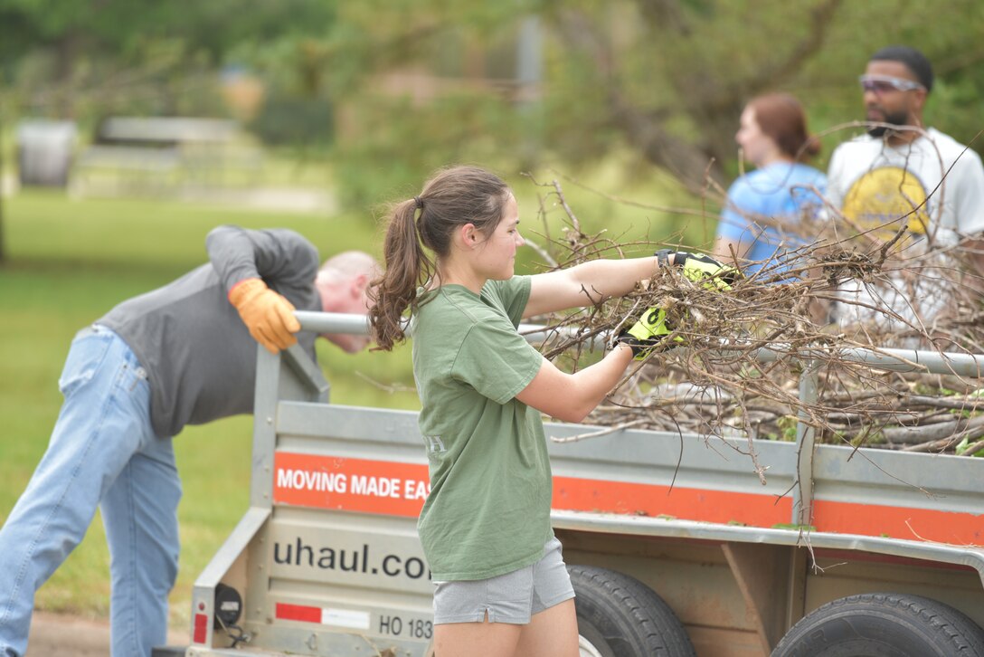 Team members from Sheppard Air Force Base load a truck with debris as part of the Colbert Project local cleaup