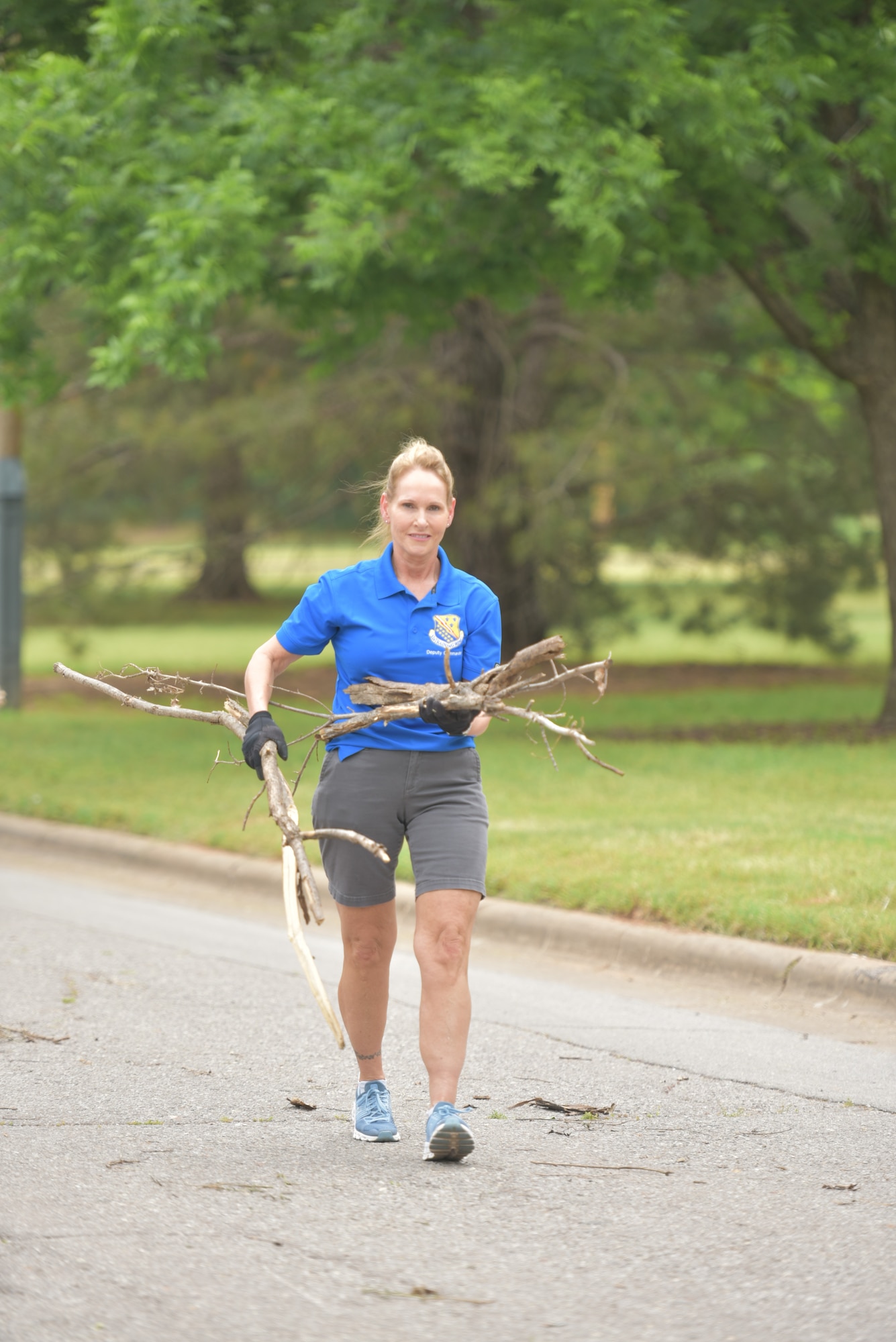 ol. Kellie S. Courtland, Deputy Commander, 82d Training Wing, collects debris as part of the Colbert Project local cleaup