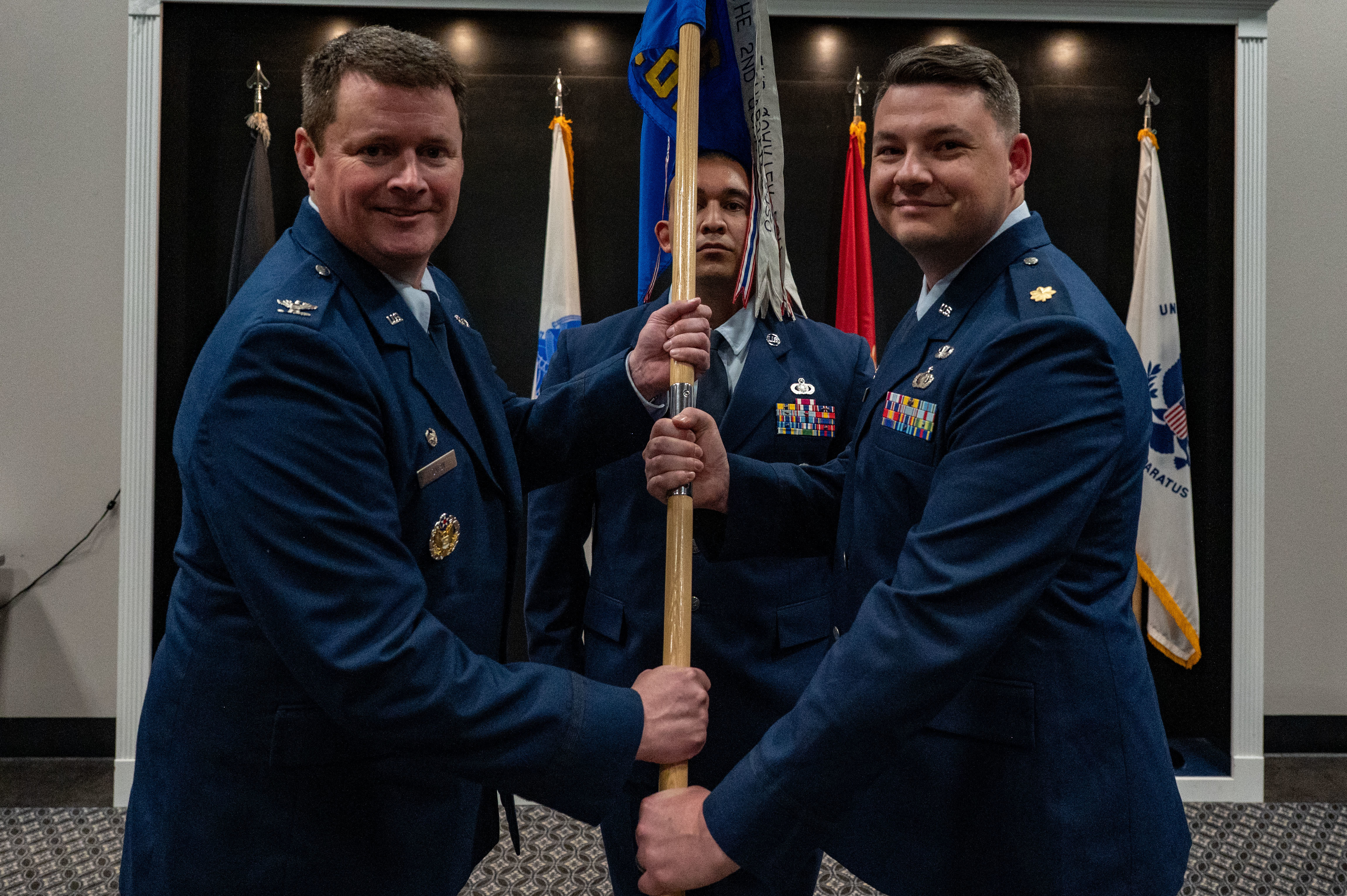 U.S. Air Force Col. Timothy Dalby, 17th Mission Support Group commander, passes the guidon to Maj. Thomas A. Redfield, 17th Contracting Squadron incoming commander, upon assuming command during the assumption of command ceremony at the Powell Event Center, Goodfellow Air Force Base, Texas, June 4, 2025. The mission of the 17th CONS is to create agile, innovative, mission-focused business solutions essential to train, develop and inspire the future force. (U.S. Air Force photo by Airman 1st Class James Salellas)