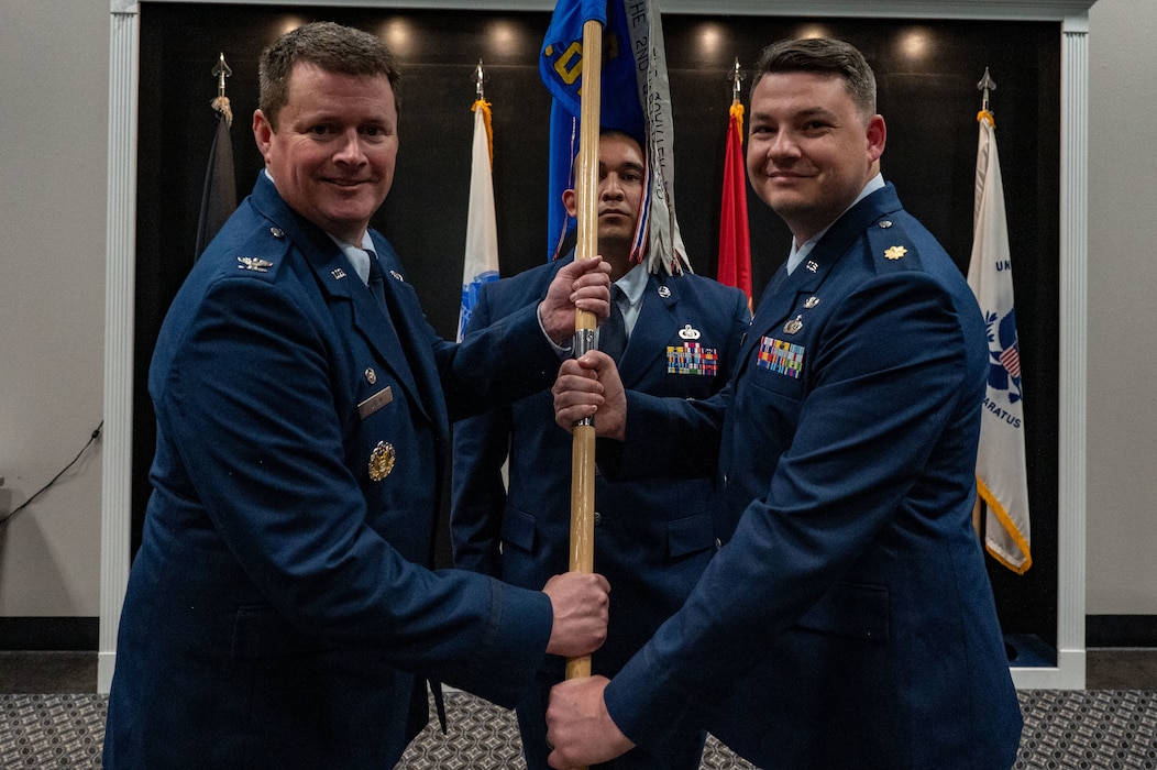 U.S. Air Force Col. Timothy Dalby, 17th Mission Support Group commander, passes the guidon to Maj. Thomas A. Redfield, 17th Contracting Squadron incoming commander, upon assuming command during the assumption of command ceremony at the Powell Event Center, Goodfellow Air Force Base, Texas, June 4, 2025. The mission of the 17th CONS is to create agile, innovative, mission-focused business solutions essential to train, develop and inspire the future force. (U.S. Air Force photo by Airman 1st Class James Salellas)