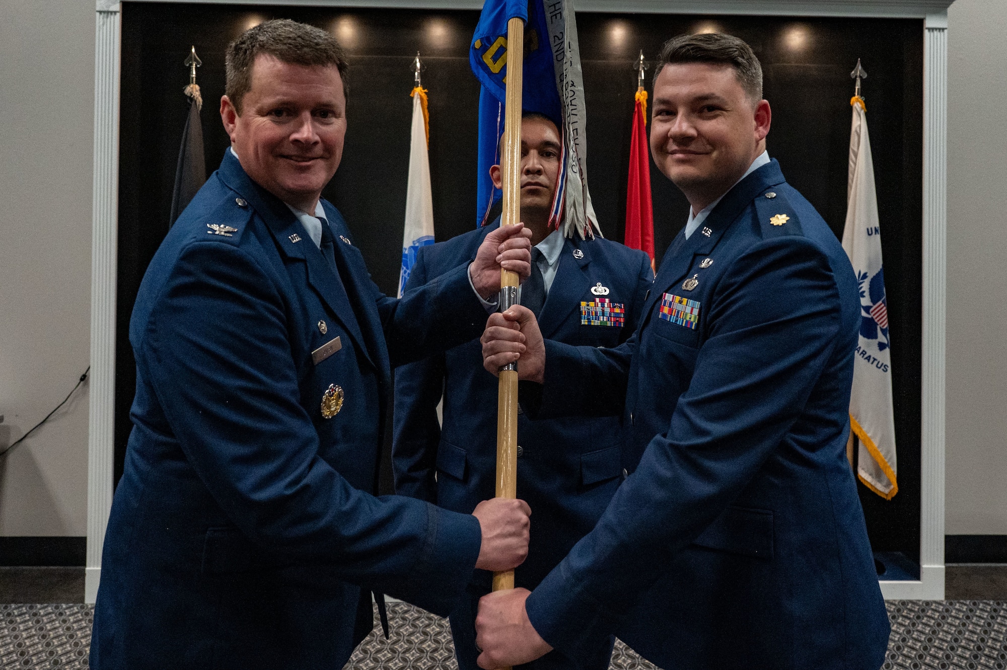 U.S. Air Force Col. Timothy Dalby, 17th Mission Support Group commander, passes the guidon to Maj. Thomas A. Redfield, 17th Contracting Squadron incoming commander, upon assuming command during the assumption of command ceremony at the Powell Event Center, Goodfellow Air Force Base, Texas, June 4, 2025. The mission of the 17th CONS is to create agile, innovative, mission-focused business solutions essential to train, develop and inspire the future force. (U.S. Air Force photo by Airman 1st Class James Salellas)