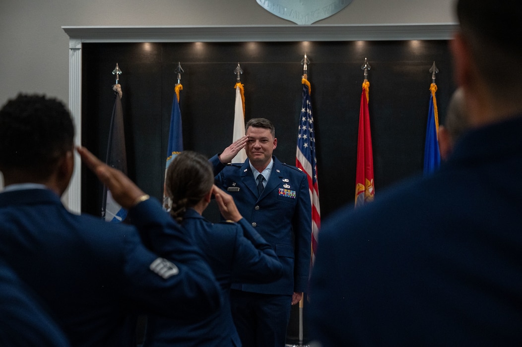 U.S. Air Force Airmen assigned to the 17th Contracting Squadron salute  Maj. Thomas A. Redfield, 17th CONS incoming commander, at the Powell Event Center, Goodfellow Air Force Base, Texas, June 4, 2025. The salute represents the squadron welcoming its new commander. (U.S. Air Force photo by Airman 1st Class James Salellas)