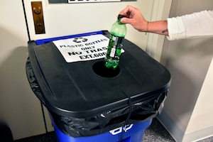 A team member at Arnold Air Force Base, Tenn., places a plastic bottle into one of the plastic recycling bins located throughout the installation May 30, 2025. The Arnold AFB Recycling Center recently announced that beginning June 16 it will no longer accept plastic materials. The move is primarily due to rising costs related to the collection, sorting and processing of recyclable plastics coupled with a reduced market demand for plastic across Tennessee. Other recyclables, such as aluminum cans, cardboard and paper, will still be accepted by the center. (U.S. Air Force photo by Bradley Hicks)