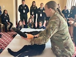 Veterinarian demonstrates care of an injured canine for class.