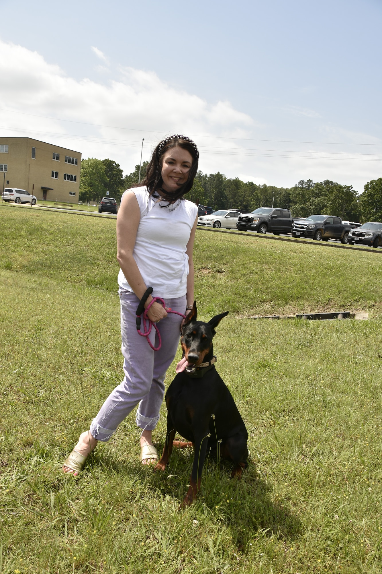 Holly Jones, OPSEC program manager for the Arnold Engineering Development Complex Information Protection Office, poses for a photo with her dog Tully Gray on May 15, 2025, during the “Operation Pupsicle” event hosted by the AEDC Information Protection Office at Arnold Air Force Base, Tenn., headquarters of AEDC, to coincide with National OPSEC Awareness Month. The AEDC IP team held events throughout May to promote the importance of operations security, more commonly referred to as OPSEC, among the AEDC workforce. (U.S. Air Force photo by Kali Bradford)