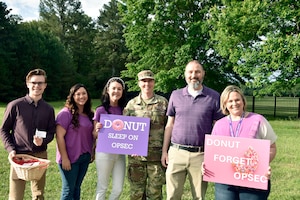 The Arnold Engineering Development Complex Information Protection Team poses for a photo with AEDC Senior Enlisted Leader Chief Master Sgt. Jennifer Cirricione, third from right, following May 22, 2025, hosted by the IP team to coincide with National OPSEC Awareness Month. The AEDC IP team held events throughout May to promote the importance of operations security, more commonly referred to as OPSEC, among the AEDC workforce. Arnold AFB is the headquarters of AEDC. Also pictured, from left, are Security Manager Caleb Gott, Security Manager Tori Duvall, AEDC OPSEC Program Manager Holly Jones, AEDC IP Chief Jared Allen and AEDC IP Deputy Chief Sara Liner. (U.S. Air Force photo by Bradley Hicks)