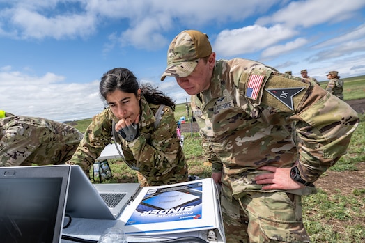  SCHRIEVER SPACE FORCE BASE,  Colo. -- U.S. Space Force Major Natalia Pinto, Chief, Commander's Action Group, analyzes the tactical challenge with Specialist 3 Damien Schloesser, Defensive Cyber Operator, during the SPOC Top Guardian competition at Schriever Space Force Base, Colorado on June 3, 2023. Spoc Top Guardian featured multiple tactical and physical waystations to test Guardian's mental and physical prowess. (U.S. Space Force Photo by Dalton Prejeant)