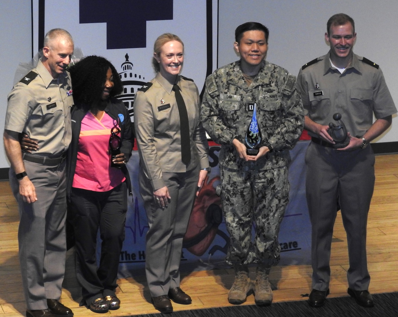 U.S. Army Col. Kenneth Dwyer (left), Commander of the Leader Training Brigade at Fort Jackson, South Carolina, thanks and recognizes members of Walter Reed's nursing team during a recent nurse appreciation and awards program at the medical center.