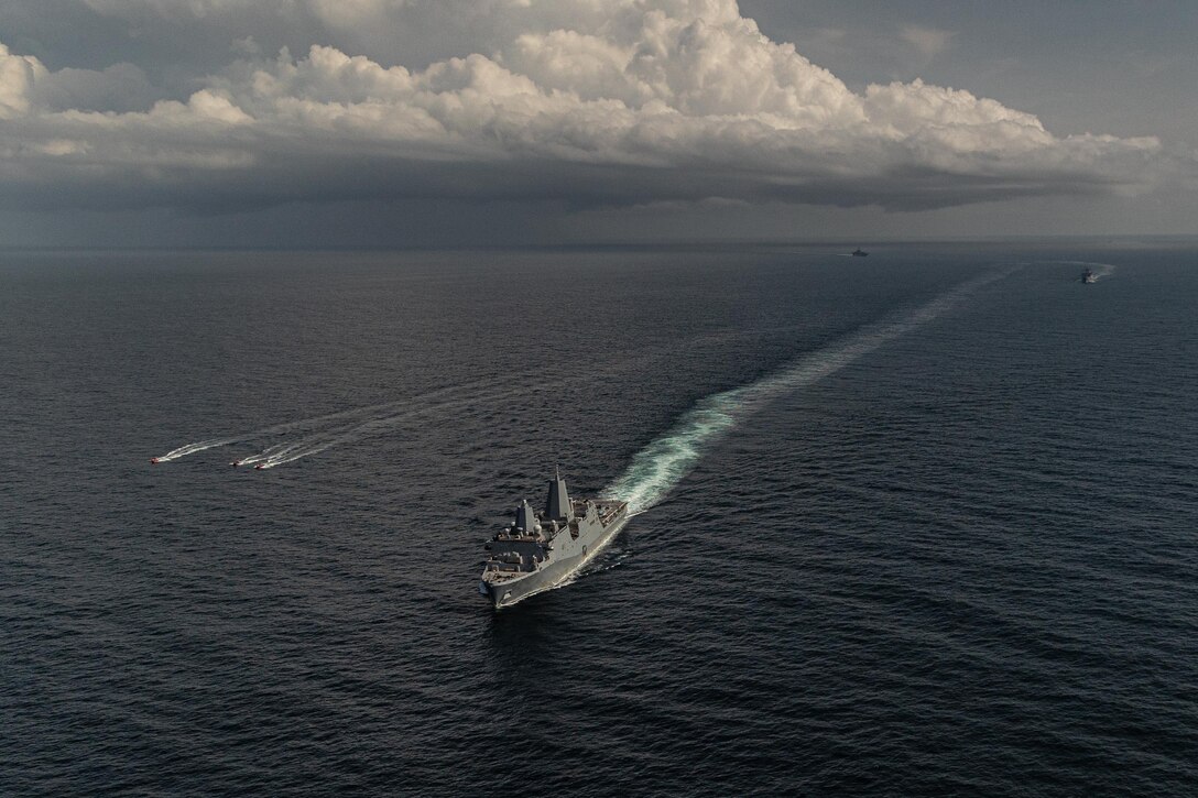 Iwo Jima Amphibious Ready Group sail in formation in the Atlantic Ocean during simulated strait transit in support of Iwo Jima Amphibious Ready Group Marine Expeditionary Unit Exercise while underway in the Atlantic Ocean, May 27, 2025. During ARGMEUEX, the 22nd MEU, aboard IWO ARG shipping, conducts various mission essential tasks that enhance operational readiness as a unified IWOARG/22 MEU team. (U.S. Marine Corps photo by Cpl. Emily Hazelbaker)