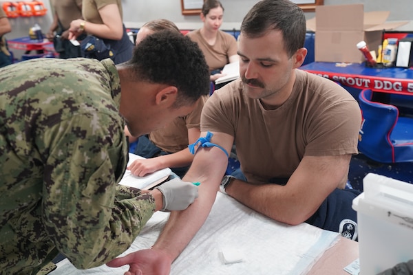 250521-N-FT324-9706. ROTA, SPAIN (May 21, 2025). Hospital Corpsman 3rd Class Neko Henderson, from Naval Medical Readiness Training Command (NMRTC), Rota, assists with laboratory draws aboard the USS Stout (DDG 55), supporting Individual Medical Readiness (IMR) requirements. These efforts ensure Sailors are medically prepared for deployment while also allowing NMRTC personnel to maintain clinical proficiency in operational environments. (U.S. Navy Photo by Lt. Cmdr. Alicia Sacks)