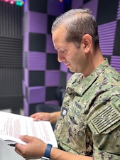 250604-N-TY711-8595 SIGONELLA, Italy. (June 4, 2025) Cmdr. Radhames Lizardo, Director for Surgical Services and General Surgeon, assigned to U.S. Naval Hospital Sigonella, preparing for a recording for a Patient Informational Minute segment on AFN Sigonella with Captain TaRail A. Vernon. Cmdr. Lizardo discussed the importance of colorectal cancer screenings. The broadcast, recorded on June 4 in Sigonella, Italy, underscores U.S. Naval Hospital Sigonella’s continued commitment to health and readiness. (U.S. Navy photo by Lieutenant Commander Brandi Gibson)