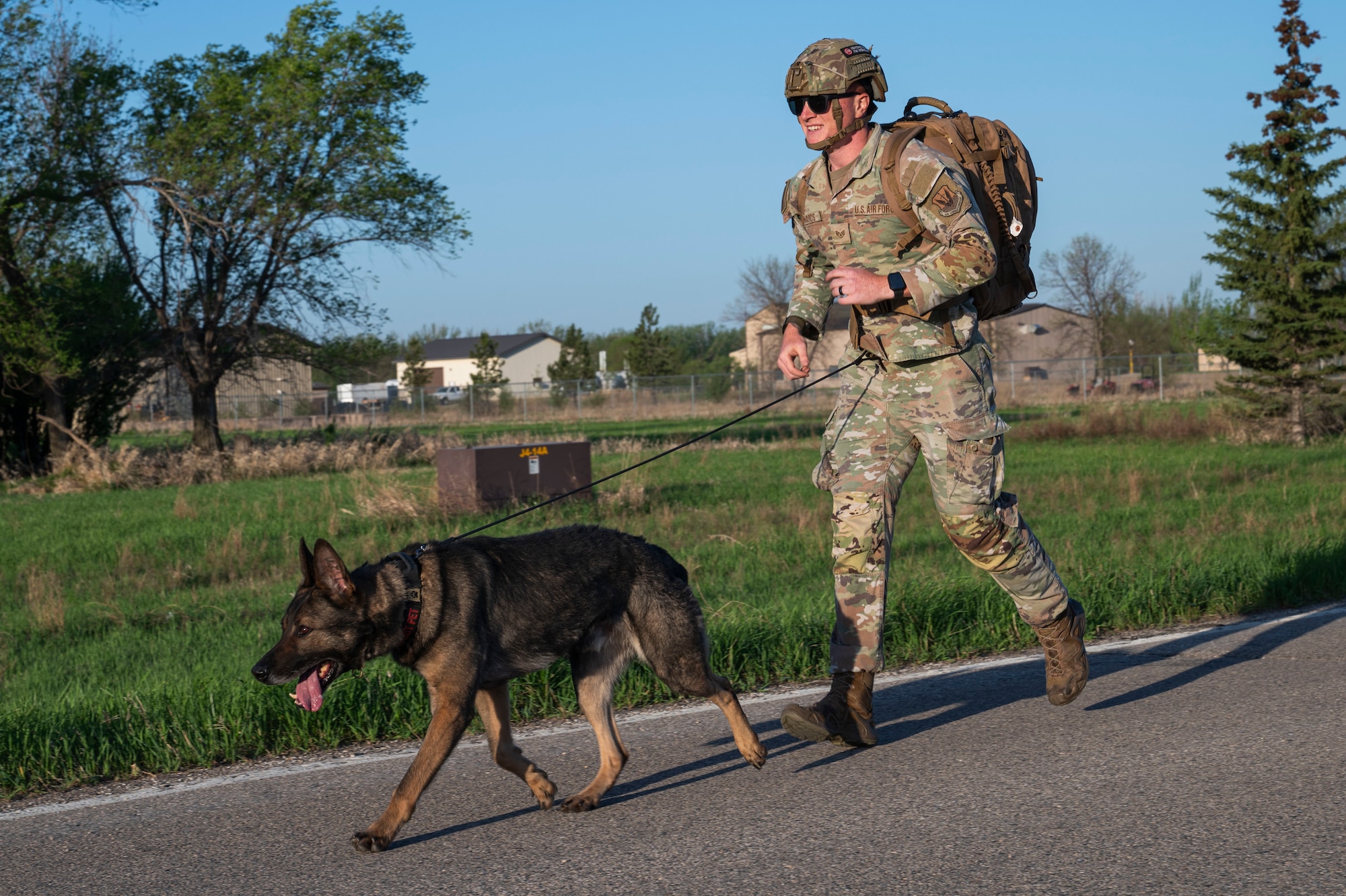 Staff Sgt. James Edwards, 319th Security Forces Squadron military working dog handler, participates in a Police Week ruck with his partner, Zorro, 319th SFS MWD, at Grand Forks Air Force Base, N.D., May 13, 2025.