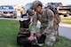 Senior Airman Caleb Manges, 319th Security Forces Squadron military working dog handler, helps Flex, 319th SFS military working dog, stretch before a two-mile ruck run at Grand Forks Air Force Base, N.D., May 13, 2025.