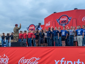 U.S. Army Brig. Gen. John P. Cogbill, XVIII Airborne Corps of Fort Bragg, N.C., administers Oath of Enlistment to 40 recruits as the crowd cheers them on at the Charlotte Motor Speedway, Concord, North Carolina, during the Coca-Cola 600 NASCAR race, May 25, 2025