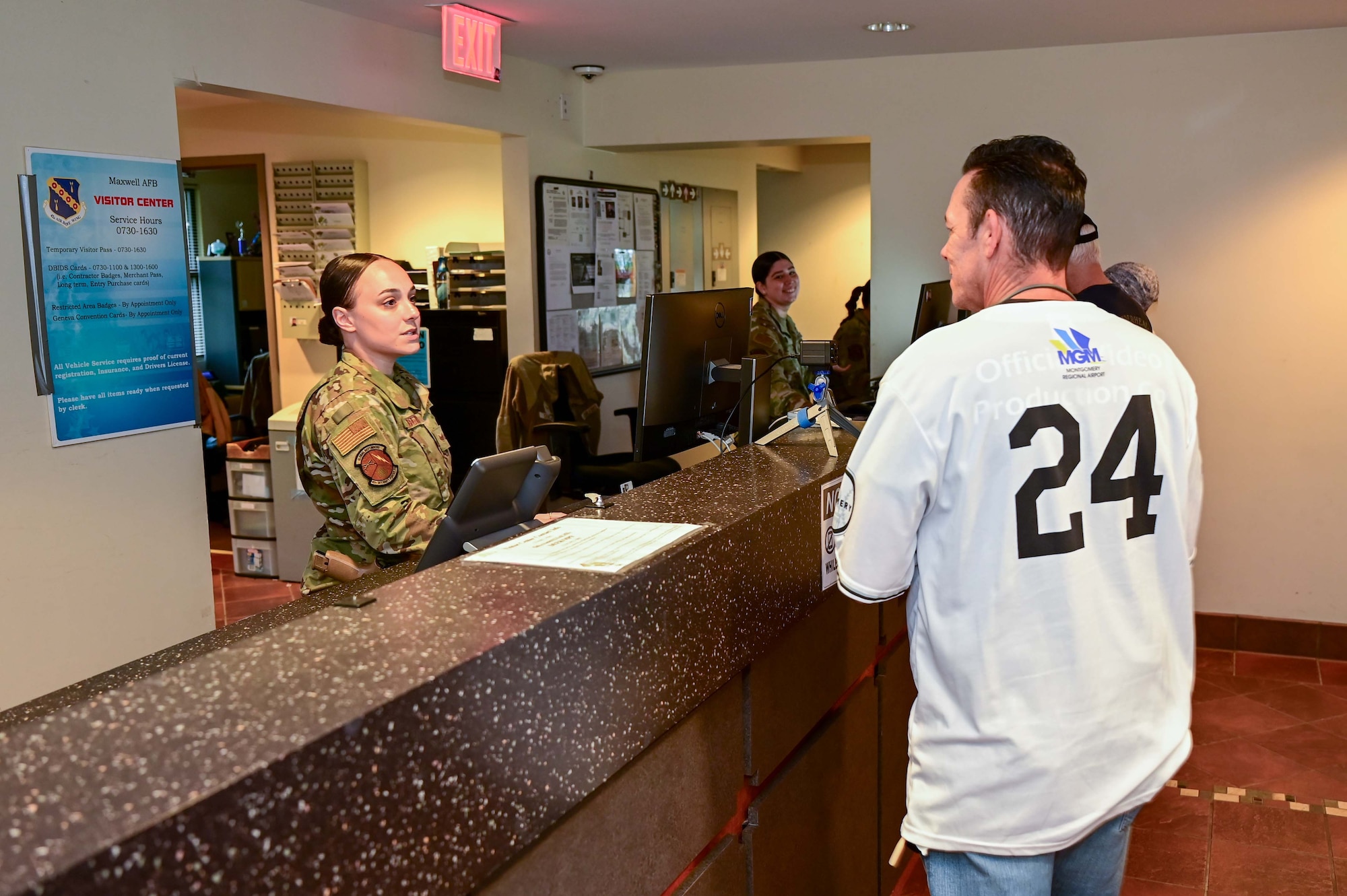 U.S. Air Force Staff Sgt. Sydnie Colbert, 42nd Security Force Squadron noncommissioned officer in charge of pass and registration, helps a customer get a visitor pass at Maxwell Air Force Base June 4, 2025.