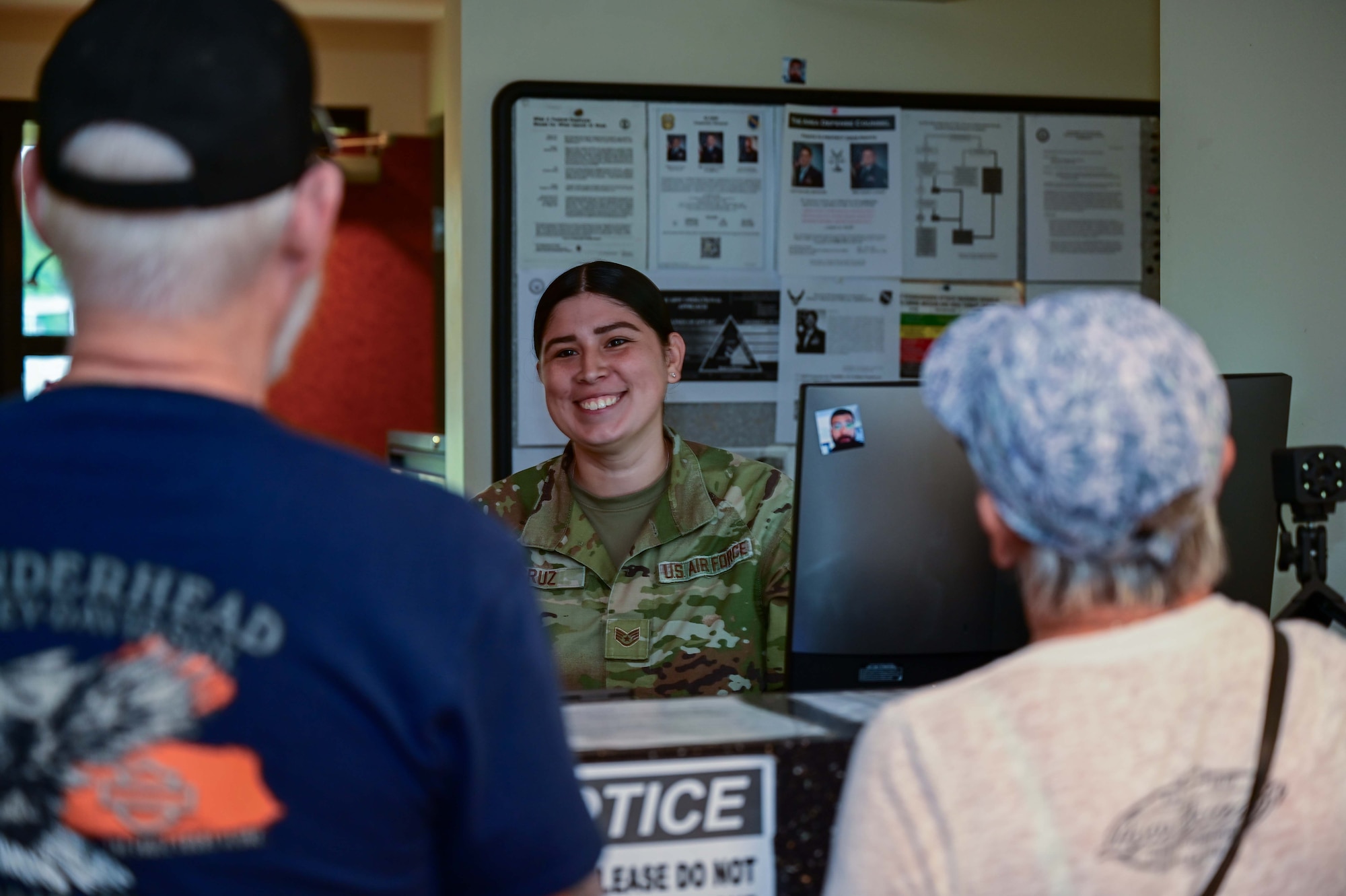 U.S. Air Force Staff Sgt. Alexis Cruz, 42nd Security Force Squadron assistant noncommissioned officer of pass and registration, helps two visitors get visitor passes at Maxwell Air Force Base June 4, 2025.