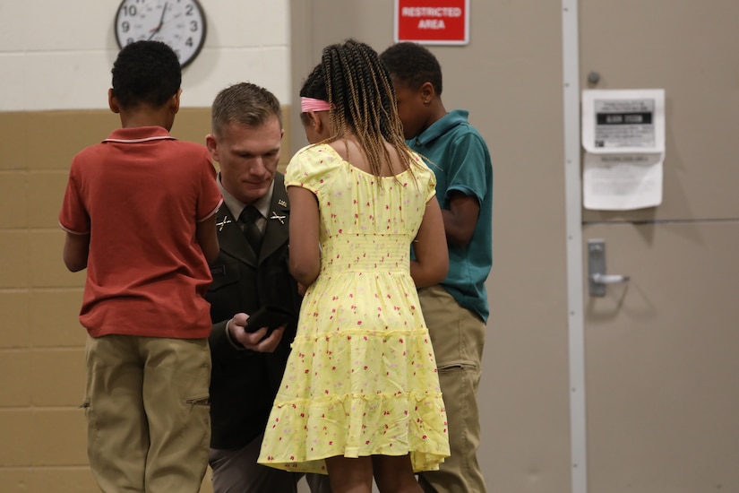 U.S. Army Col. Robert Andersen is pinned with his new rank by his children during his promotion ceremony at the Lexington Armory, May 30, 2025.