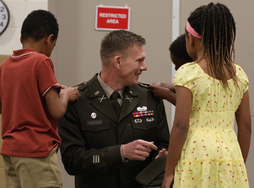 U.S. Army Col. Robert Andersen is pinned with his new rank by his children during his promotion ceremony at the Lexington Armory, May 30, 2025.