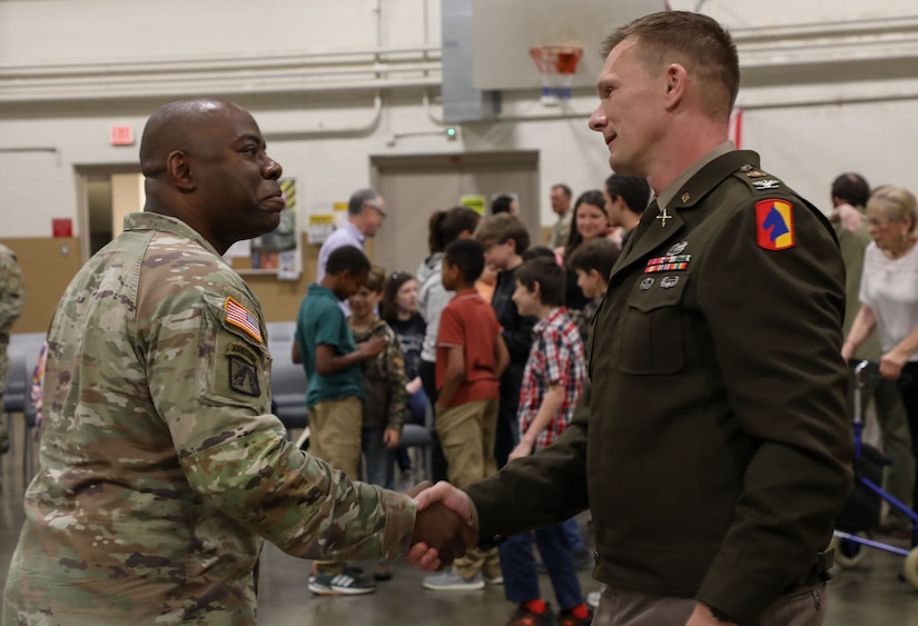 U.S. Army Lt. Col. Douglas 'Kelly' Smith congratulates Col. Robert Andersen on his promotion after a ceremony at the Lexington Armory, May 30, 2025.