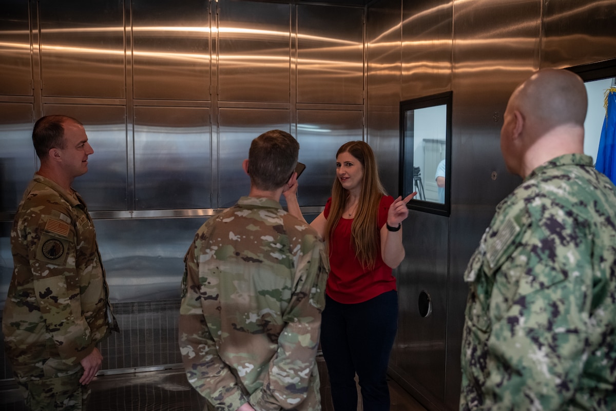 Dr. Jennifer Schwanekamp-Kerr, primary investigator, discusses the stainless steel interior of the new Research Environmental Chamber with military guests following a ribbon-cutting ceremony at Wright Patterson Air Force Base, Ohio, May 27, 2025. This state-of-the-art facility, part of the Air Force Research Laboratory’s Human Effectiveness Directorate, facilitates equipment and human performance evaluations by simulating environmental extremes. (U.S. Air Force photo / Richard Eldridge)
