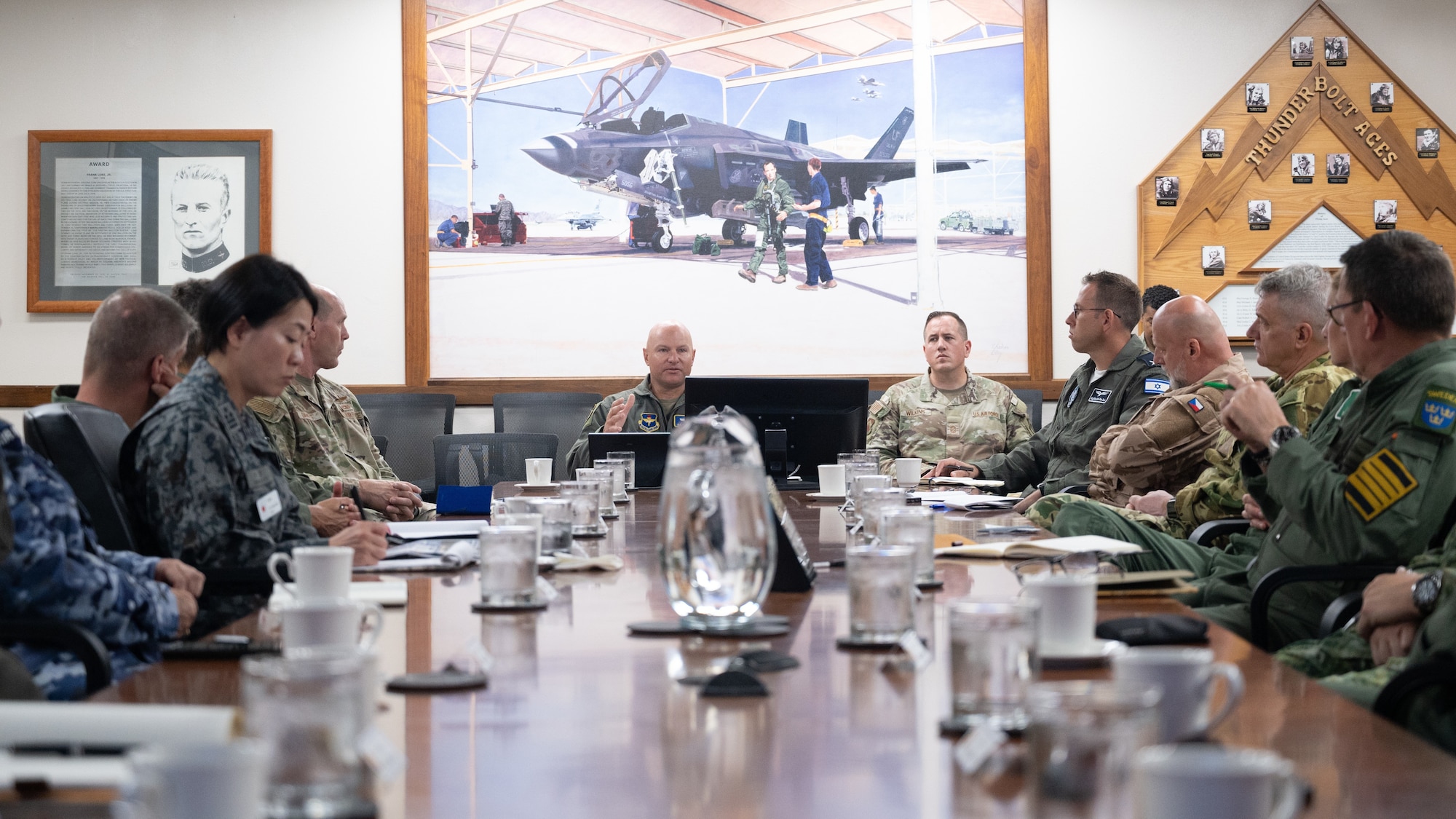 U.S. Air Force Brig. Gen. David Berkland, 56th Fighter Wing commander, hosts a roundtable discussion with defense attachés from allied and partner nations during a base visit, June 2, 2025, at Luke Air Force Base, Arizona. The roundtable focused on how Luke integrates international partners into F-35A Lightning II operations and training pipelines. (U.S. Air Force photo by Senior Airman Elias Carrero)