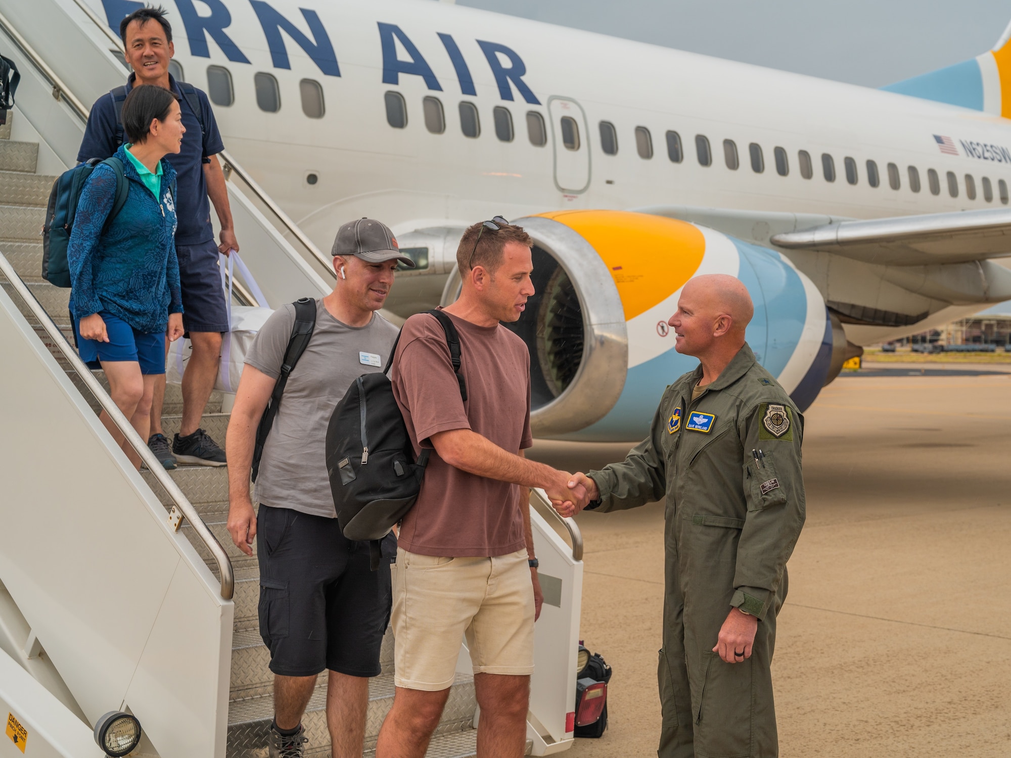 U.S. Air Force Brig. Gen. David Berkland, 56th Fighter Wing commander, greets attachés from allied and partner nations when they arrive for a base visit, June 1, 2025, at Luke Air Force Base, Arizona. Defense attachés from 17 allied and partner nations visited Luke AFB to deepen cooperation on F-35A Lightning II training and integration. The attachés, representing nations from Europe, the Middle East, Asia, and Oceania, received an in-depth look at how the United States and its partners are advancing fifth-generation fighter integration. (U.S. Air Force photo by Richard McManus)