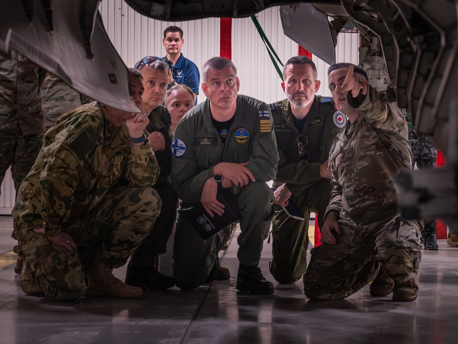 Defense attachés from allied and partner nations view the bomb bay of an F-35A Lightning II during a base visit, June 2, 2025, at Luke Air Force Base, Arizona. Defense attachés from 17 allied and partner nations visited Luke Air Force Base to deepen cooperation on F-35 training and integration. The attachés, representing nations from Europe, the Middle East, Asia, and Oceania, received an in-depth look at how the United States and its partners are advancing fifth-generation fighter integration. (U.S. Air Force photo by Senior Airman Elias Carrero)