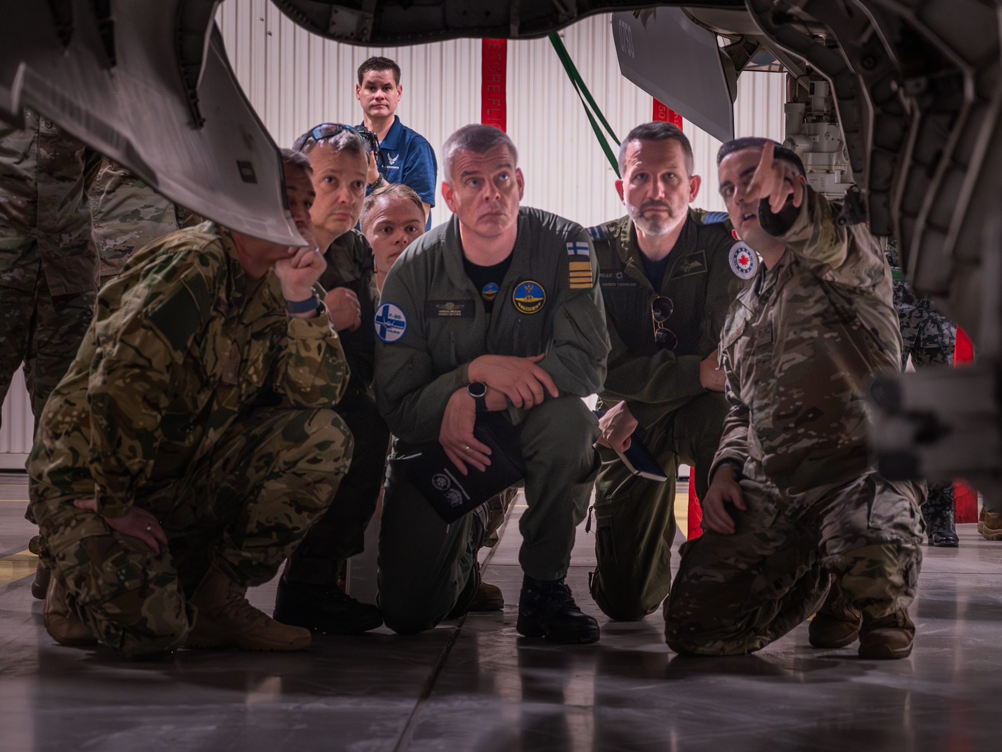 Defense attachés from allied and partner nations view the bomb bay of an F-35A Lightning II during a base visit, June 2, 2025, at Luke Air Force Base, Arizona. Defense attachés from 17 allied and partner nations visited Luke Air Force Base to deepen cooperation on F-35 training and integration. The attachés, representing nations from Europe, the Middle East, Asia, and Oceania, received an in-depth look at how the United States and its partners are advancing fifth-generation fighter integration. (U.S. Air Force photo by Senior Airman Elias Carrero)