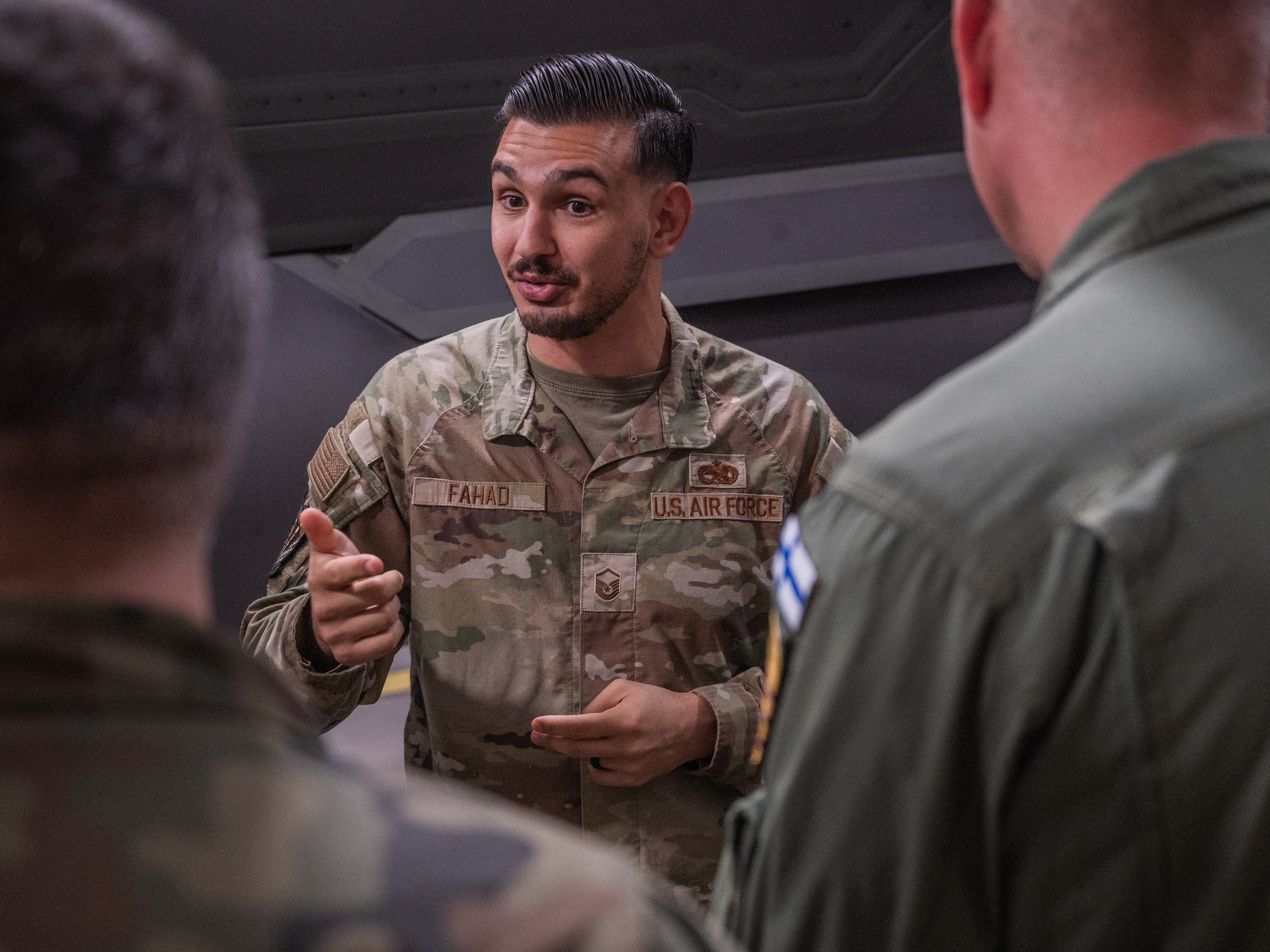 U.S. Air Force Master Sgt. Austin Fahad, 308th Aircraft Maintenance Unit weapons section chief, speaks to defense attachés from allied and partner nations during a base visit, June 2, 2025, at Luke Air Force Base, Arizona. Attachés from 17 allied and partner nations visited Luke AFB to deepen cooperation on F-35A Lightning II training and integration. The attachés, representing nations from Europe, the Middle East, Asia, and Oceania, received an in-depth look at how the United States and its partners are advancing fifth-generation fighter integration. (U.S. Air Force photo by Senior Airman Elias Carrero)
